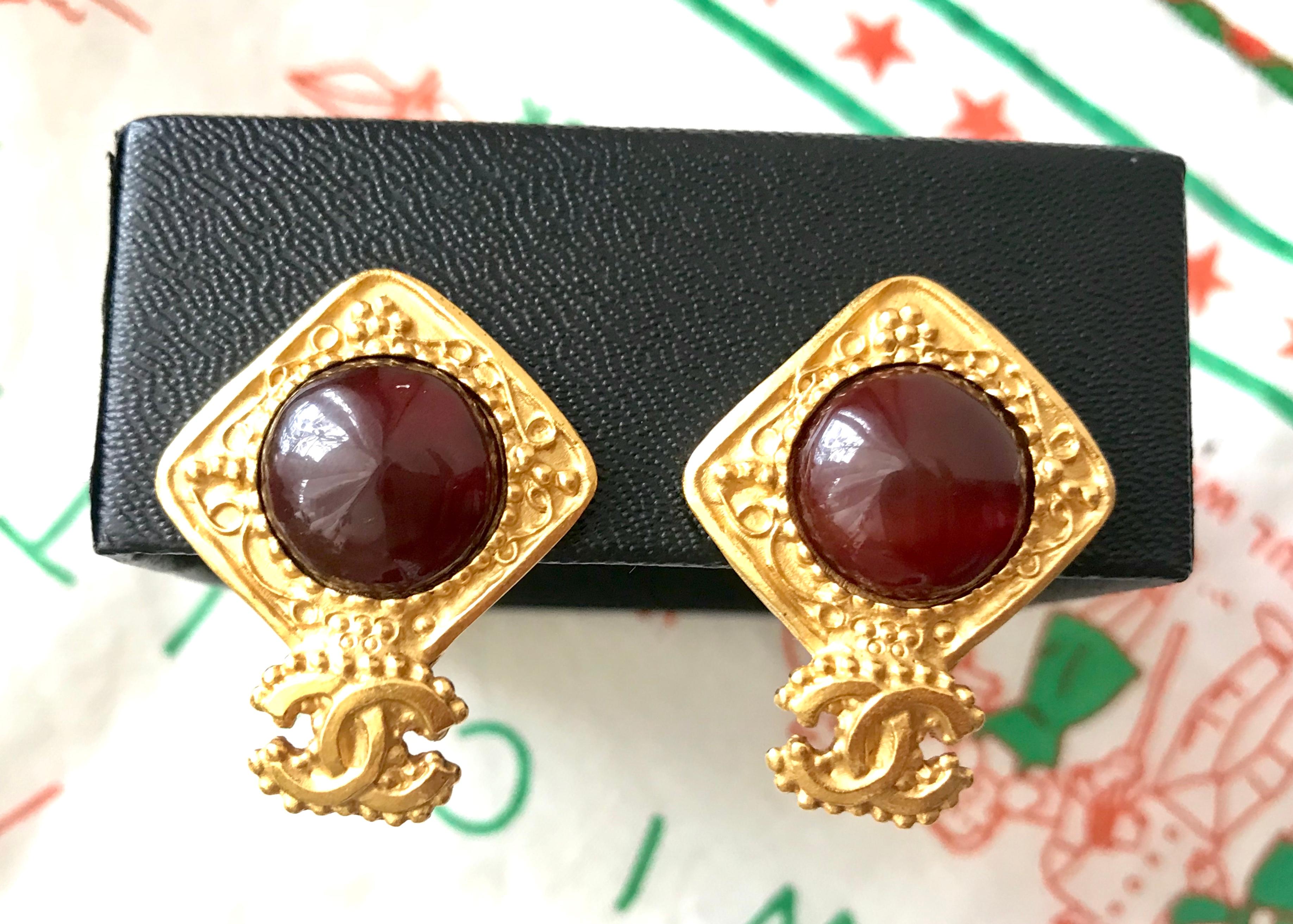 1990s. Vintage CHANEL golden square frame and wine red round gripoix glass stone earrings with CC mark. Beautiful and rare jewelry.

Introducing another rare vintage CHANEL jewelry with its iconic CC mark on it. 
Beautiful round wine red gripoix