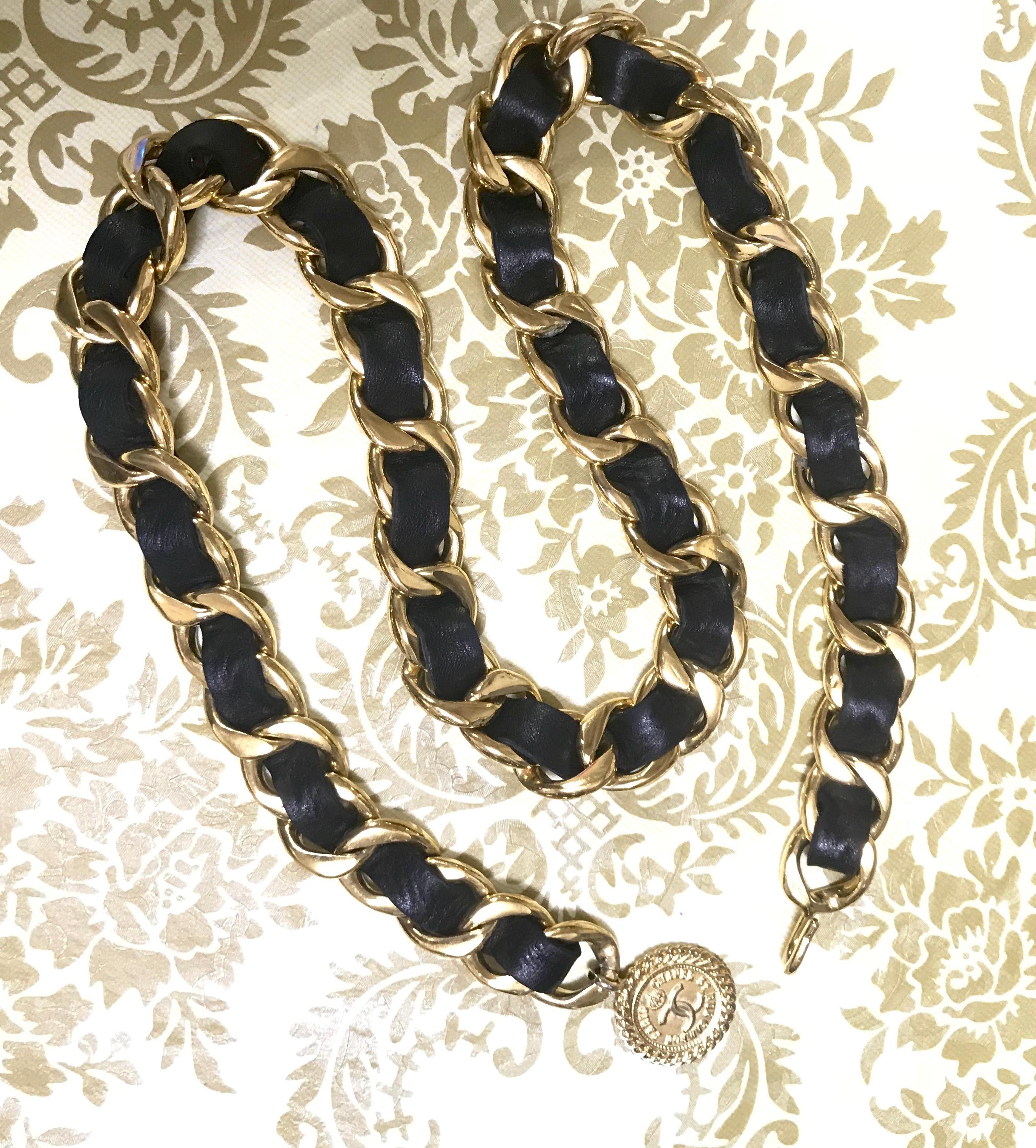****The beige version is also for sale***

1980s. Vintage CHANEL black leather thick chain belt with golden CC and mademoiselle charm. 
Nice and heavy single layer chain belt from CHANEL.

Introducing a nice and heavy black leather thick chain belt