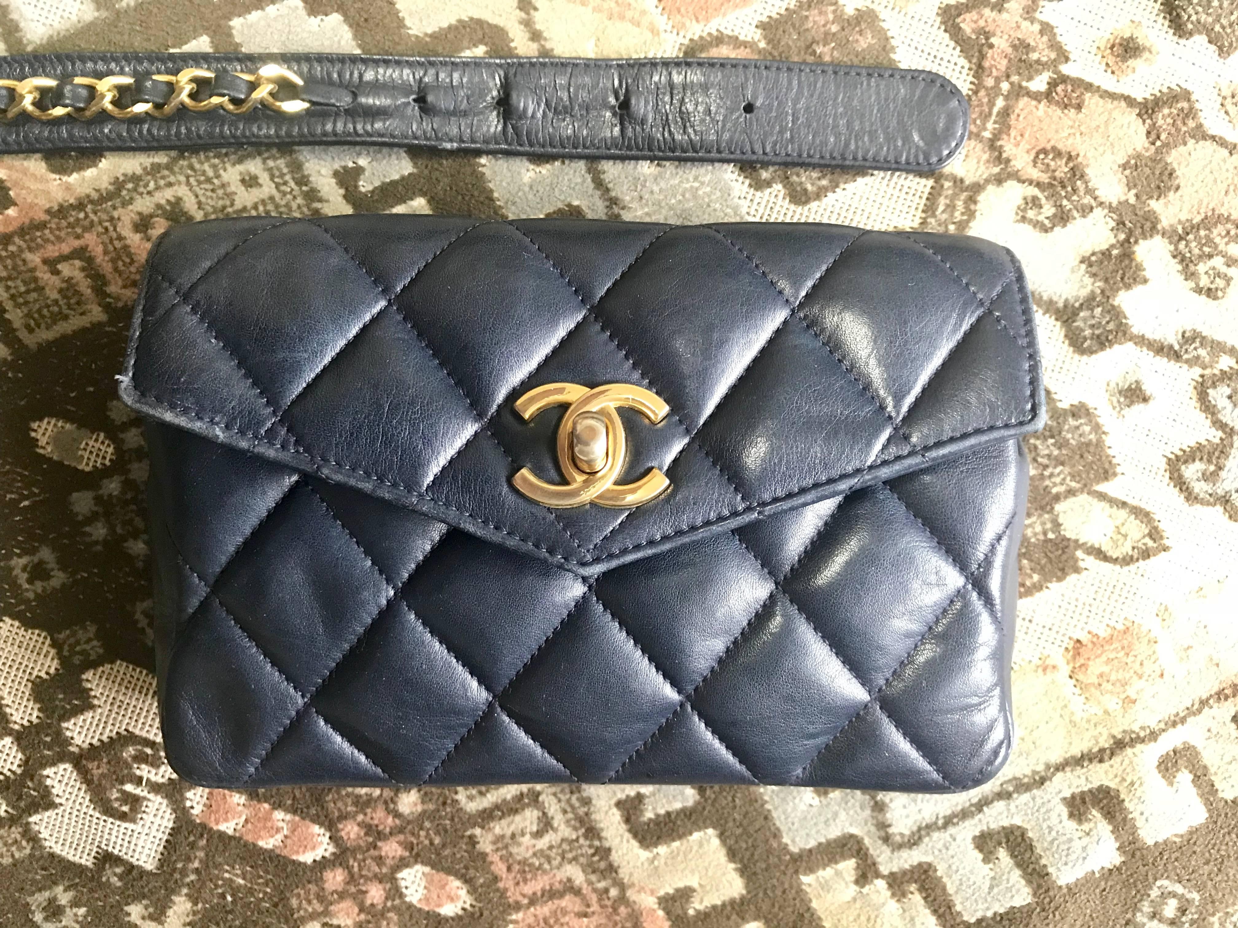 1980s. Vintage CHANEL dark navy lamb leather waist bag, fanny pack with golden chain belt & CC closure. Belt size good for 25.2