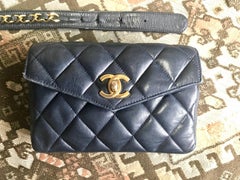 Vintage CHANEL dark navy lamb leather waist bag, fanny pack with golden chains.