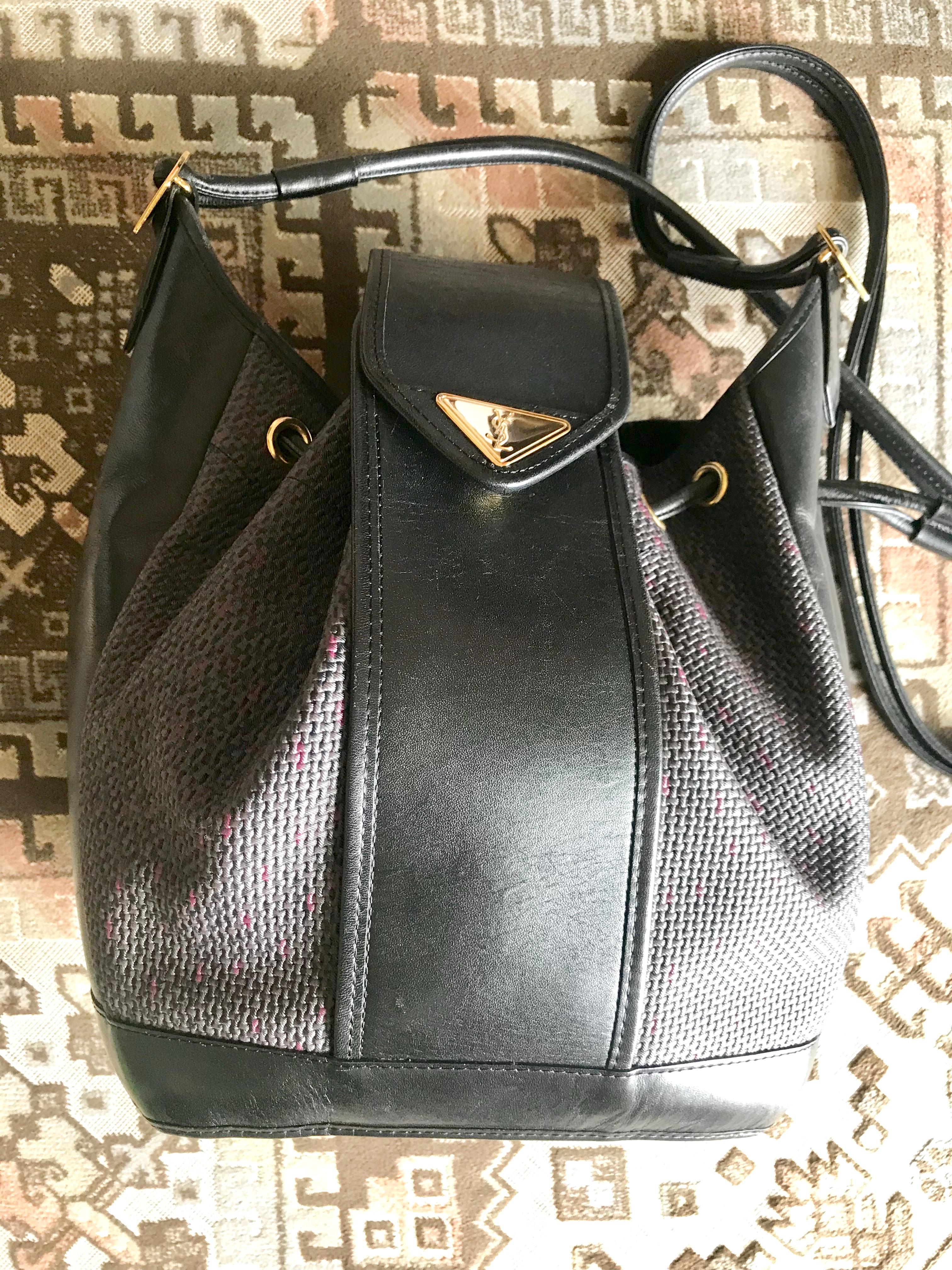 Women's or Men's Yves Saint Laurent Vintage black hobo bucket shoulder bag with golden YSL motif For Sale