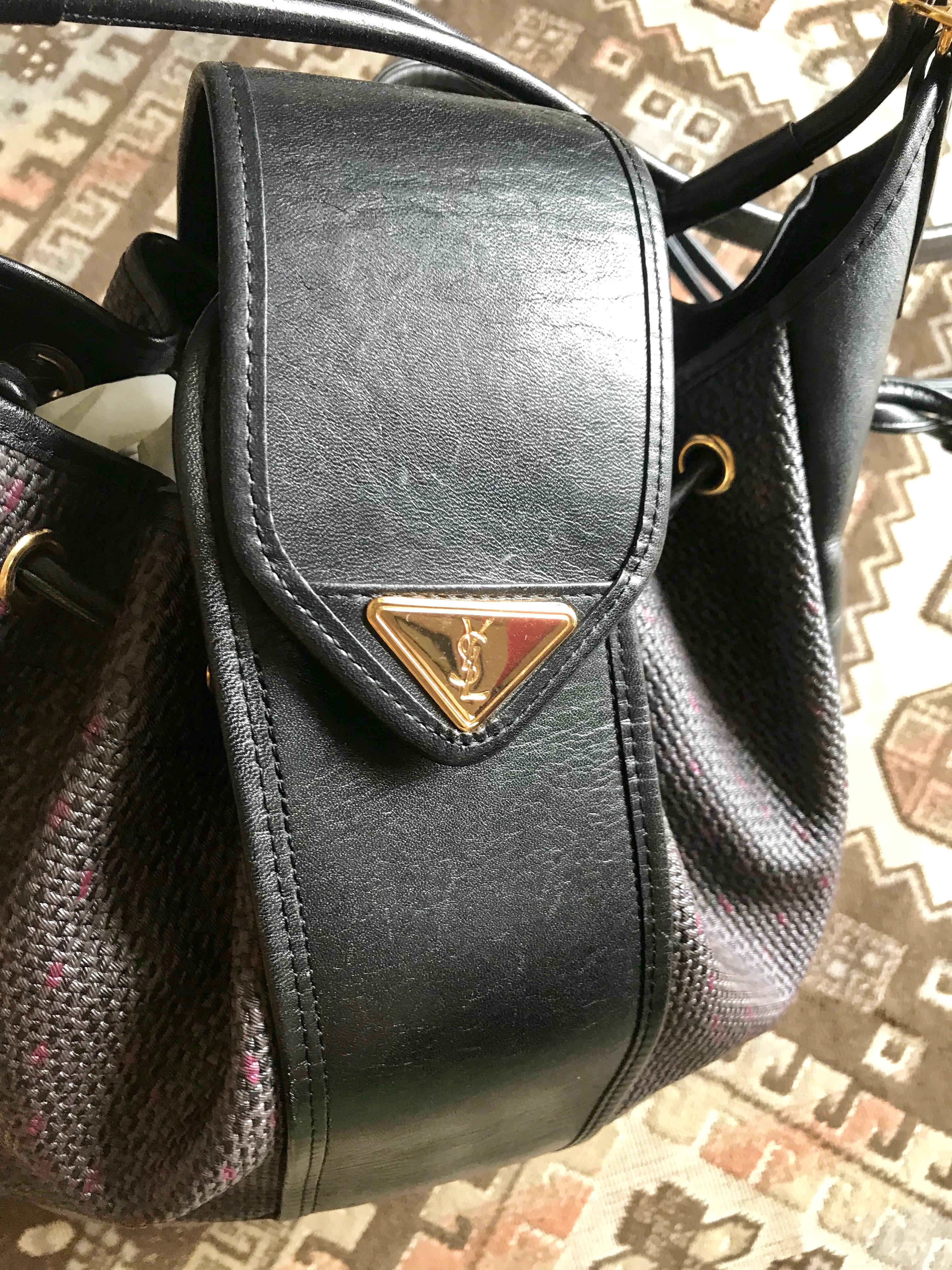 Yves Saint Laurent Vintage black hobo bucket shoulder bag with golden YSL motif For Sale 1