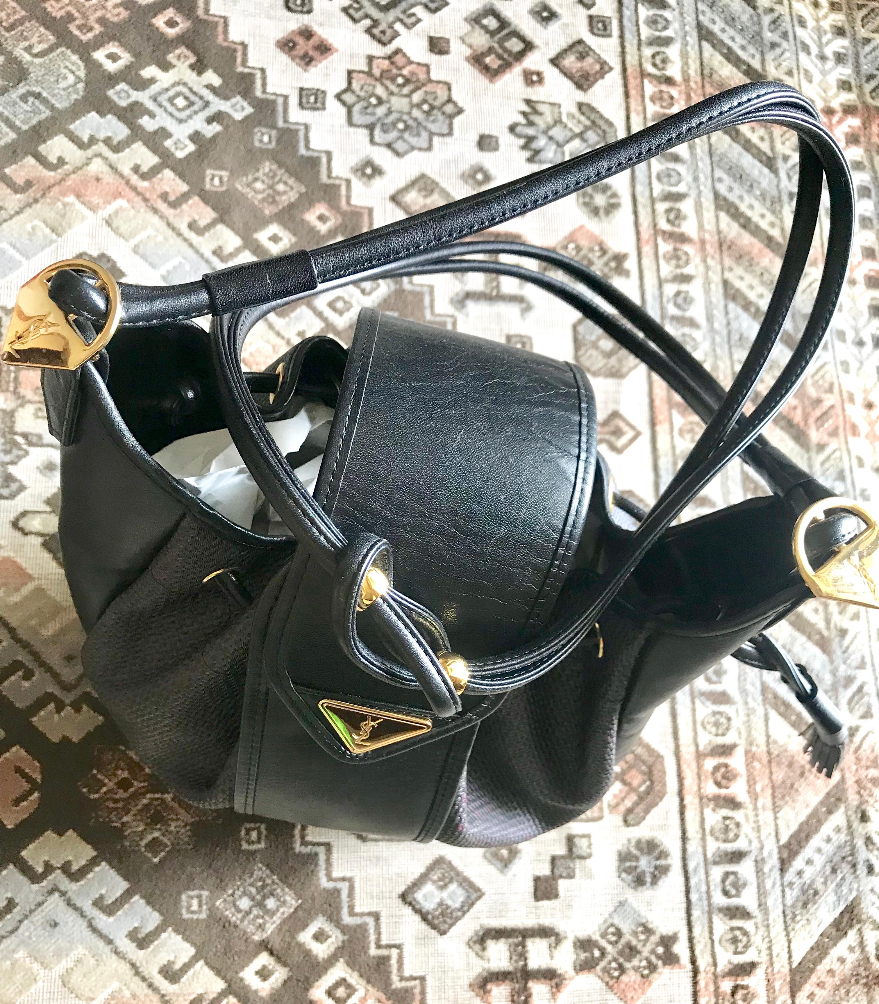 Yves Saint Laurent Vintage black hobo bucket shoulder bag with golden YSL motif For Sale 6