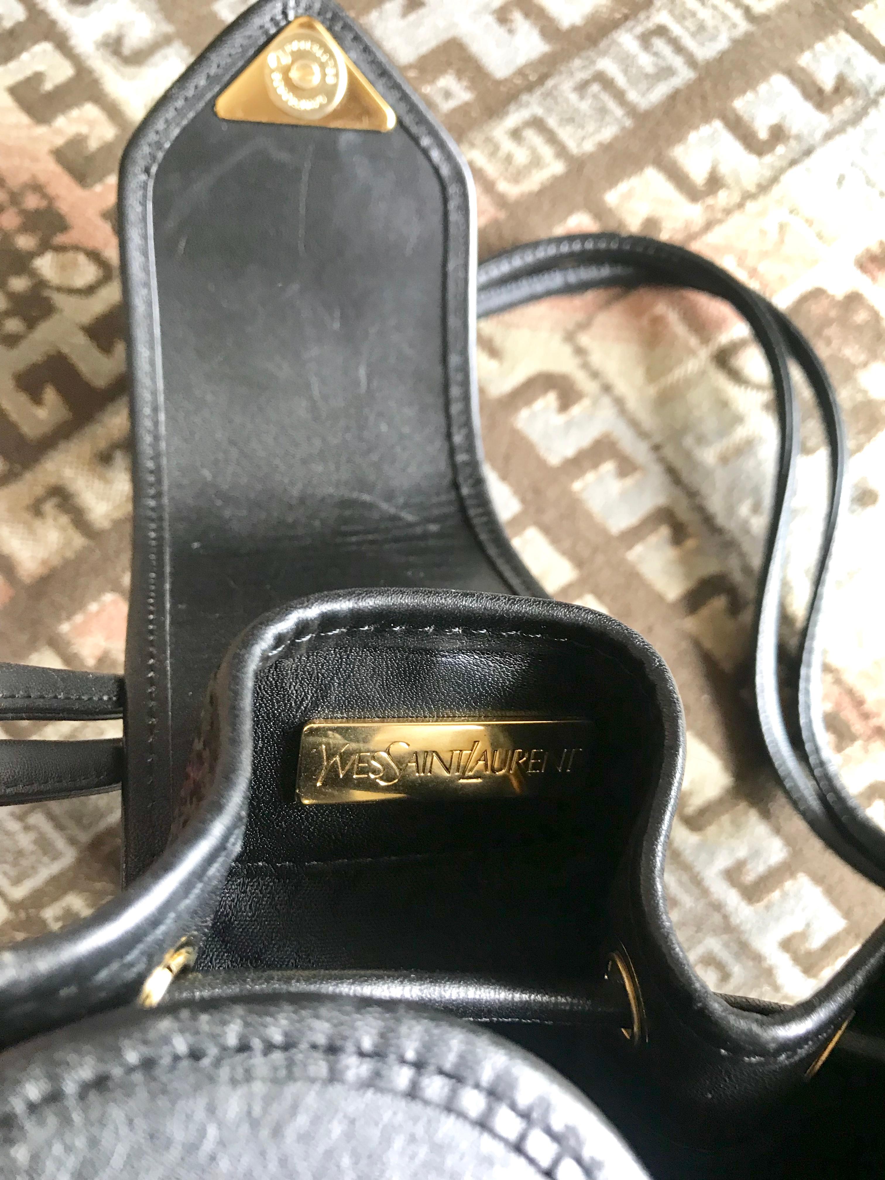Yves Saint Laurent Vintage black hobo bucket shoulder bag with golden YSL motif For Sale 8