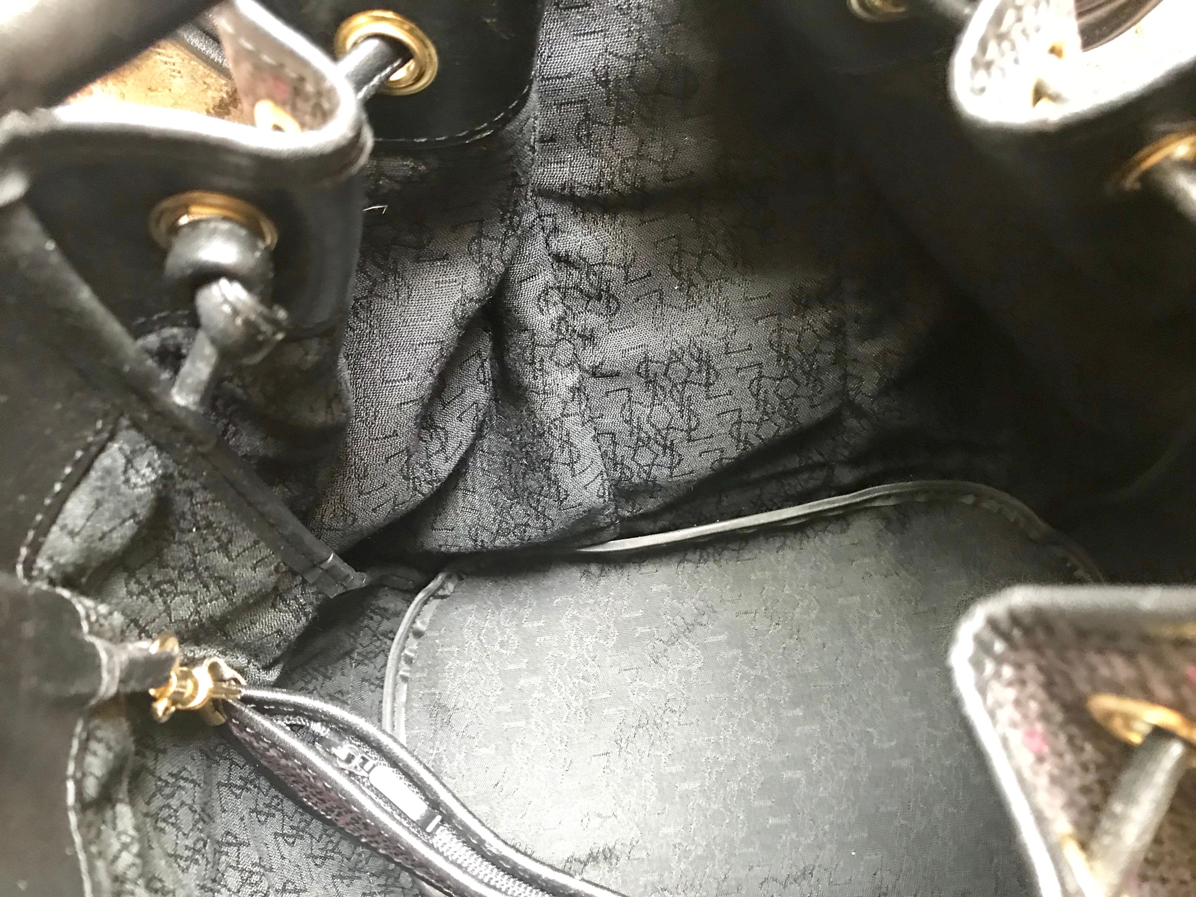 Yves Saint Laurent Vintage black hobo bucket shoulder bag with golden YSL motif For Sale 9