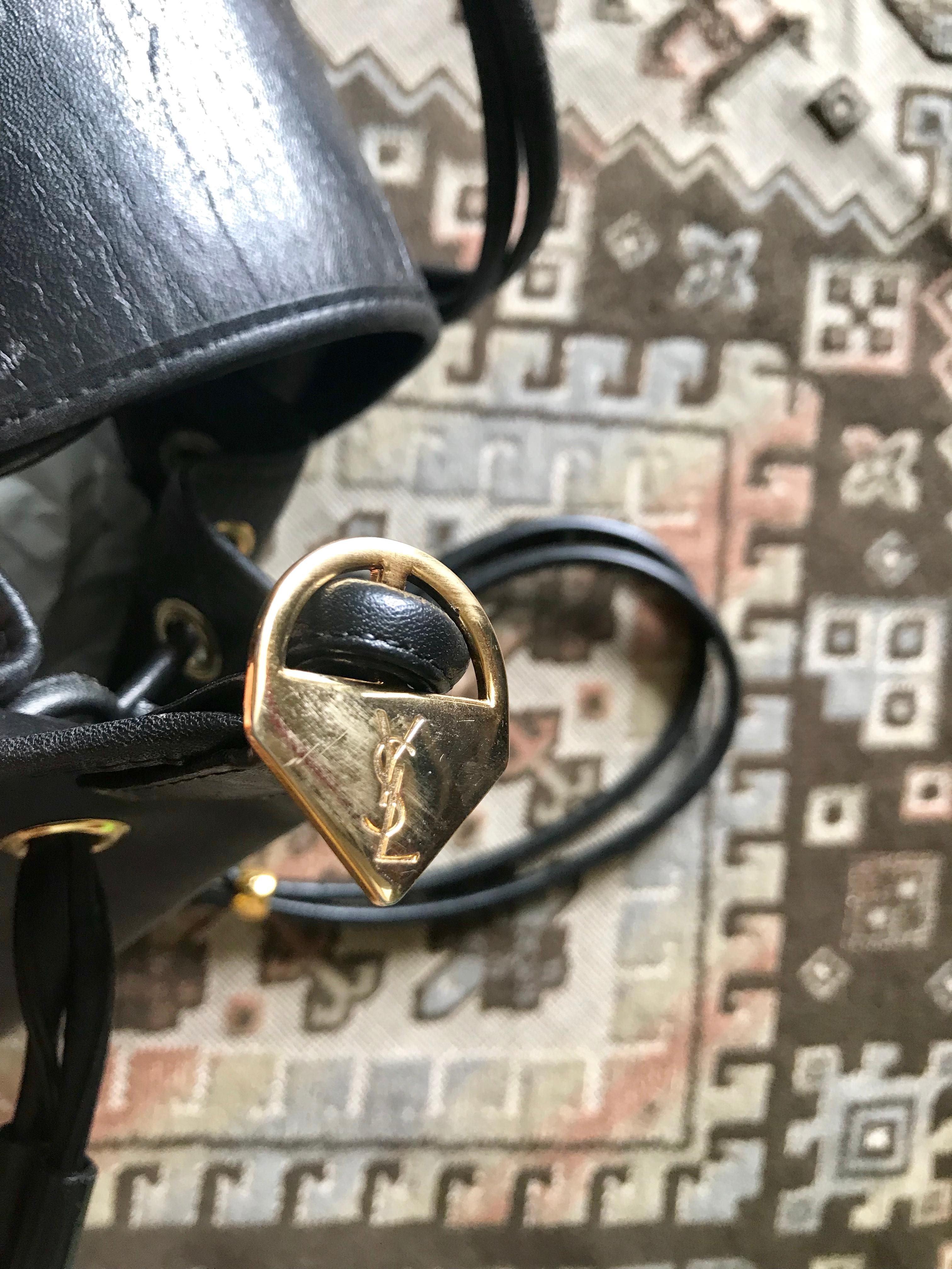 Yves Saint Laurent Vintage black hobo bucket shoulder bag with golden YSL motif For Sale 11