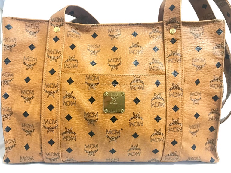 1990s. Vintage MCM brown monogram large tote bag with long shoulder straps. Classic style for unisex use. By Michael Cromer. Made in Germany.

MCM has been back in the fashion trend again!!
Now it's considered to be one of the must-have designers in