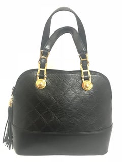 Gianni Versace Vintage black bolide shape bag with a tassel and sunburst motifs