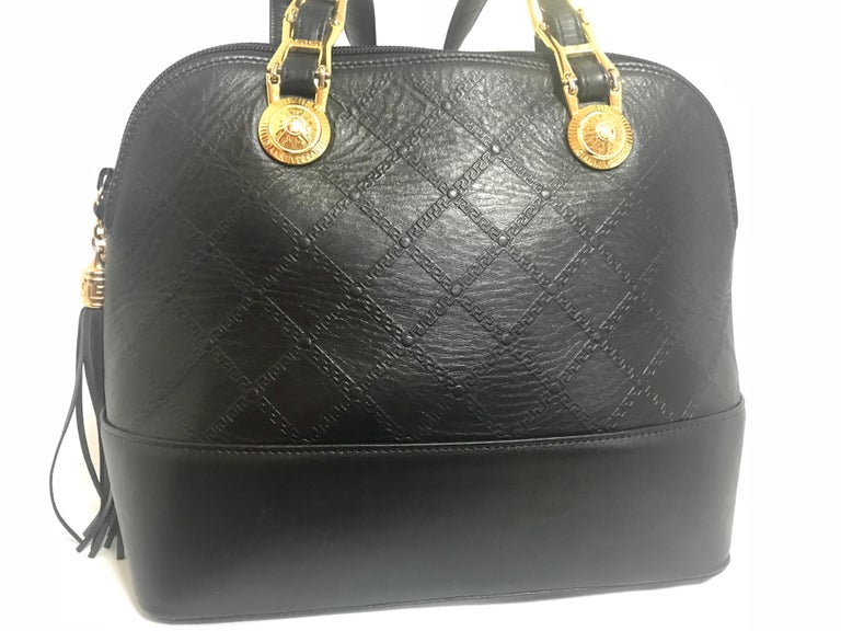 Gianni Versace Vintage black bolide shape bag with a tassel and sunburst motifs  In Good Condition For Sale In Kashiwa, Chiba