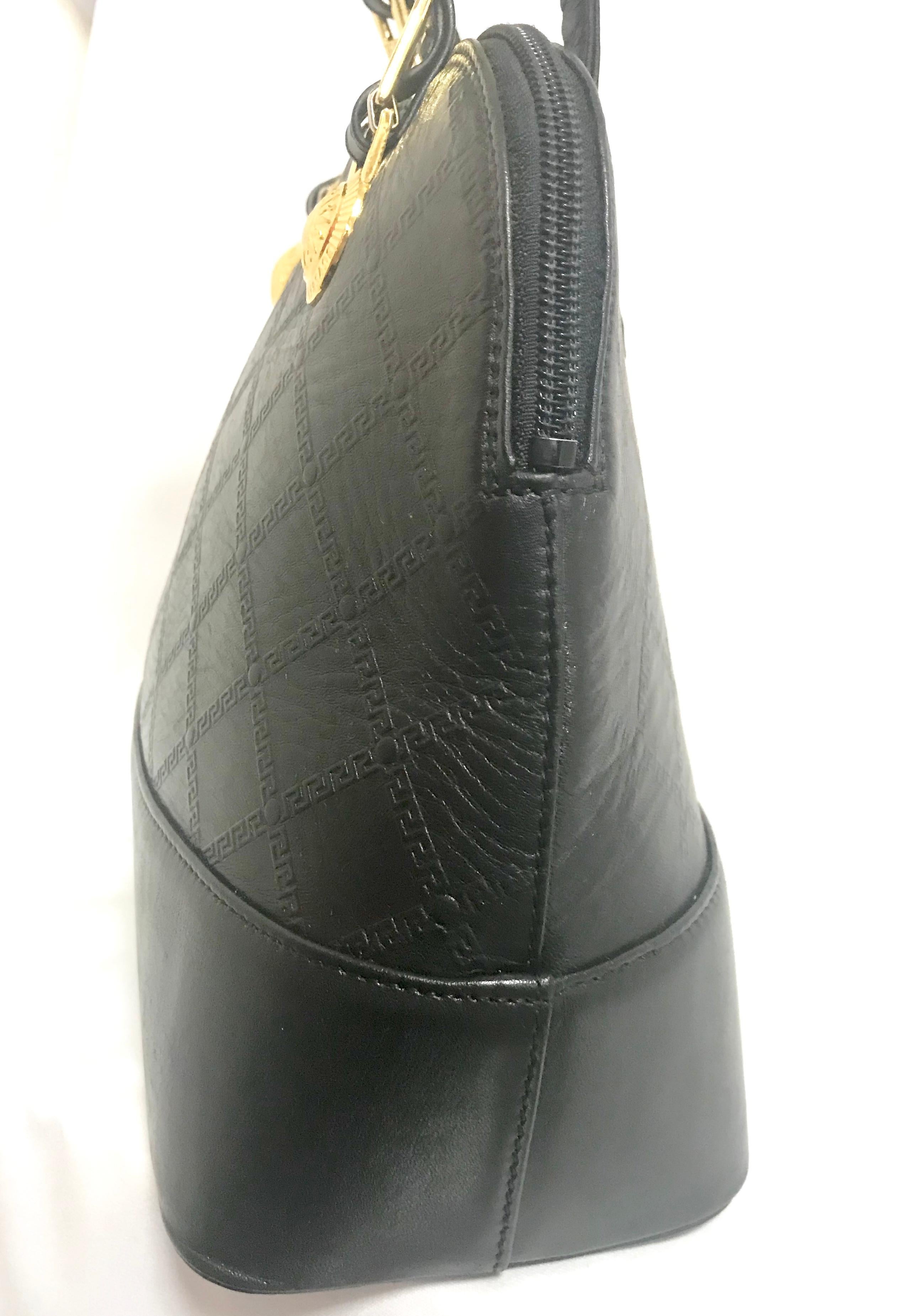 Gianni Versace Vintage black bolide shape bag with a tassel and sunburst motifs  For Sale 4