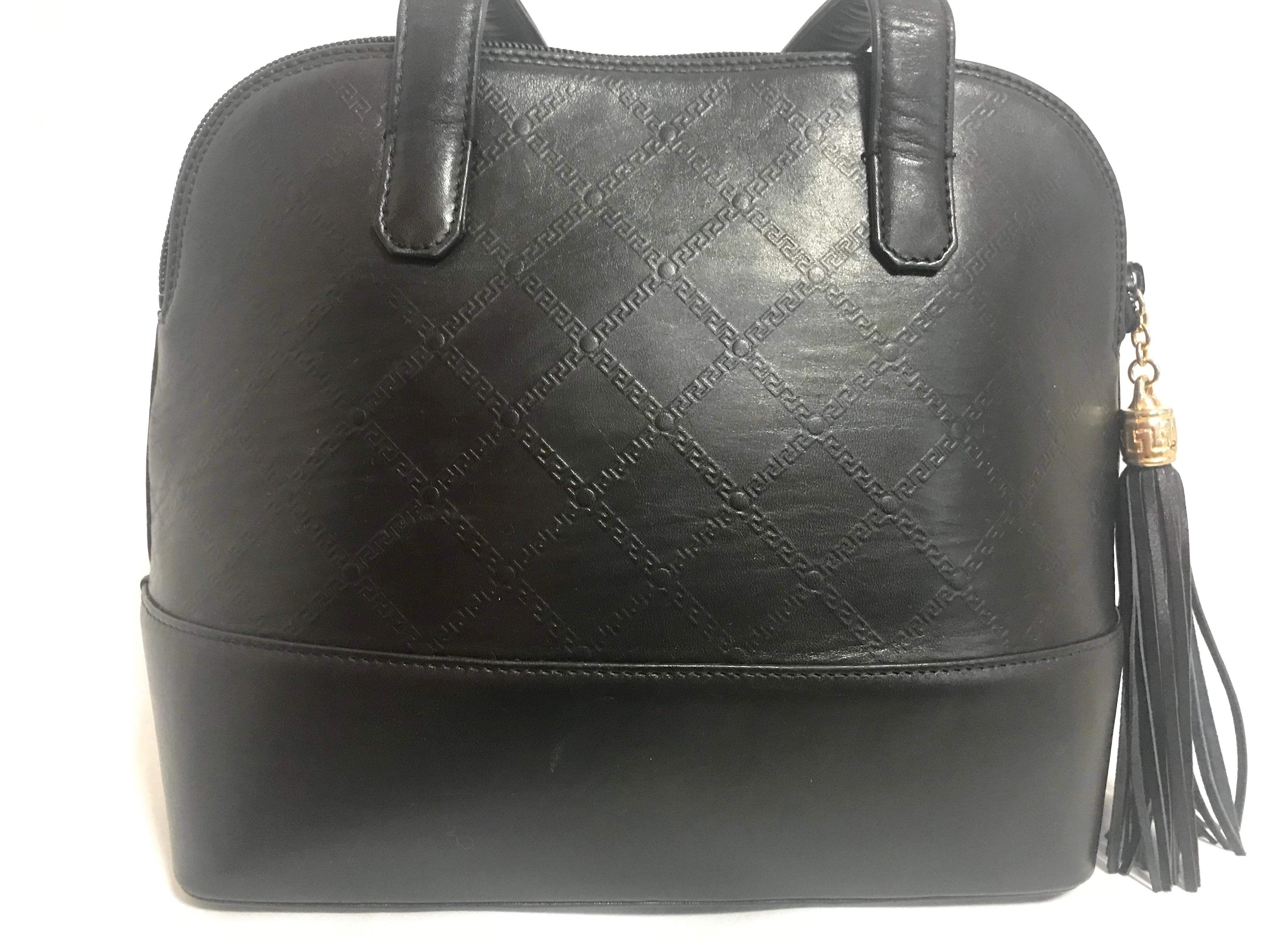Women's Gianni Versace Vintage black bolide shape bag with a tassel and sunburst motifs  For Sale