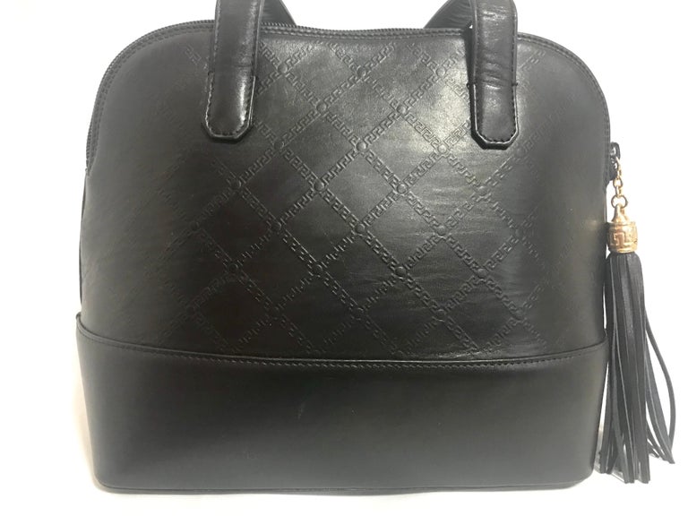 Gianni Versace Vintage black bolide shape bag with a tassel and sunburst motifs  For Sale 1
