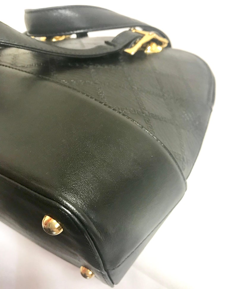 Gianni Versace Vintage black bolide shape bag with a tassel and sunburst motifs  For Sale 7