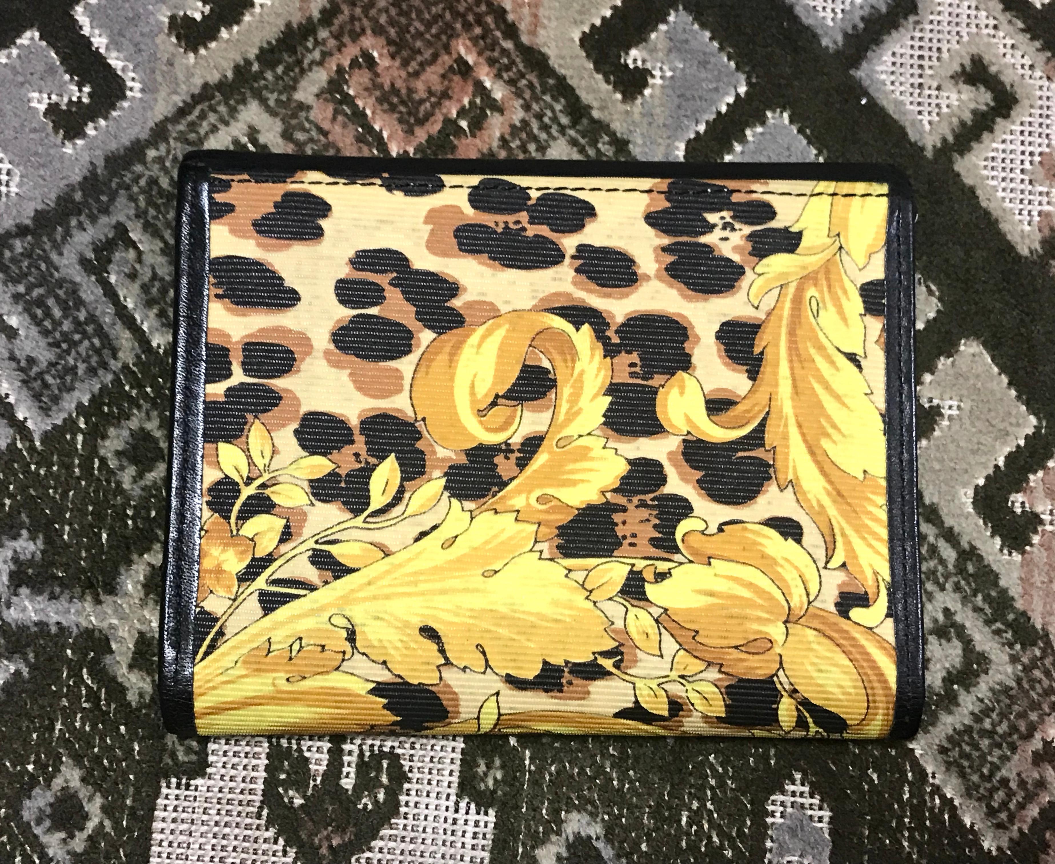 ***This wallet is for card case use only as there is no bill room and coin pocket.***

1990s. Vintage Gianni Versace black leather card case wallet with its iconic yellow and golden Edwardian arabesque print. 
Great gift for Unisex use.

For all
