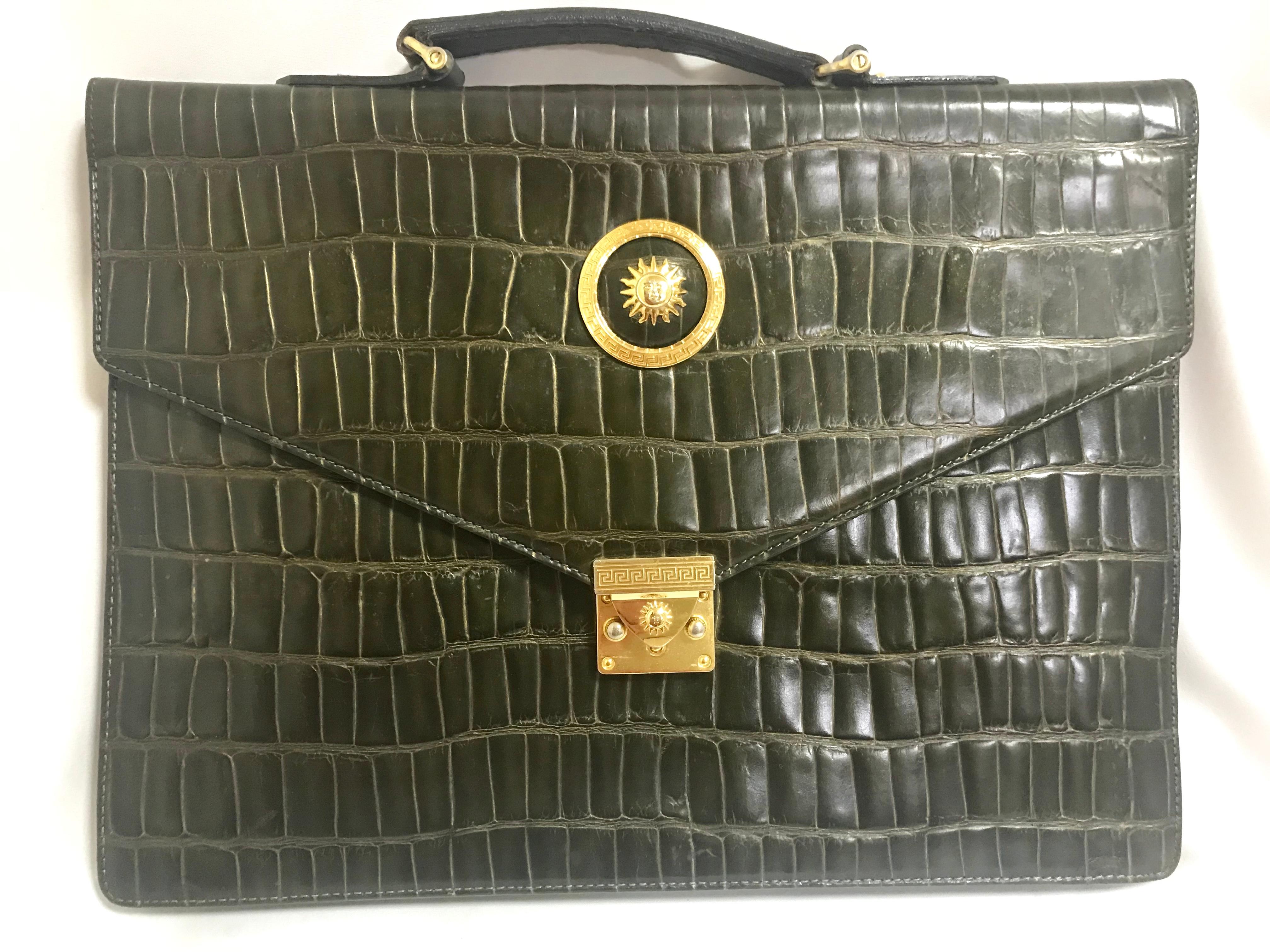 1990s. Vintage Gianni Versace dark green/khaki croc embossed leather document bag, portfolio purse with Medallion Sunburst motifs. 
Gorgeous masterpiece for unisex use. Must have bag.

This is one sophisticated masterpiece from GIANNI VERSACE in the