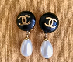 Vintage CHANEL teardrop white faux pearl earrings with black and golden CC mark