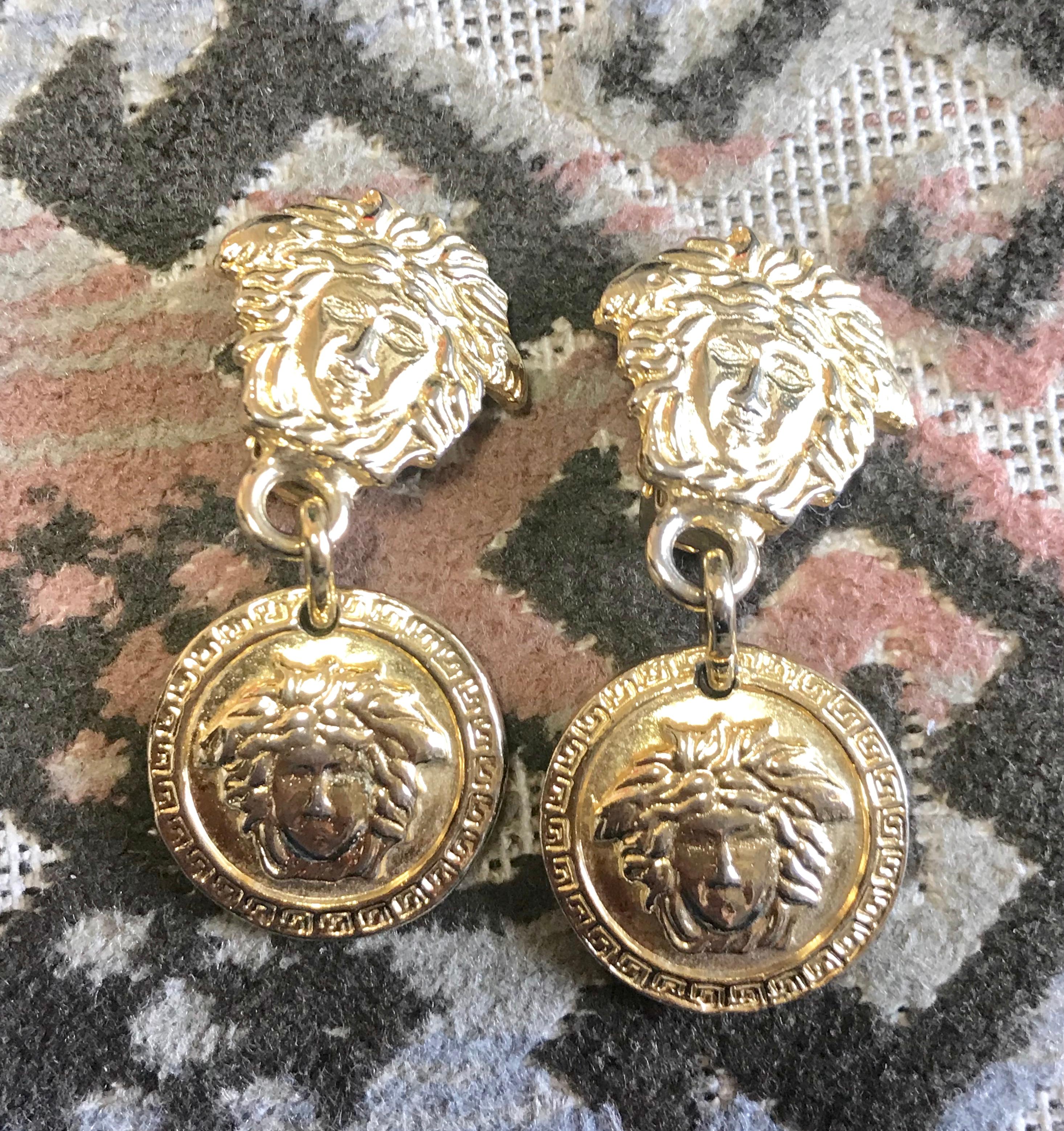 Modern Vintage Gianni Versace gold tone medusa head, face motif dangle earrings.  For Sale