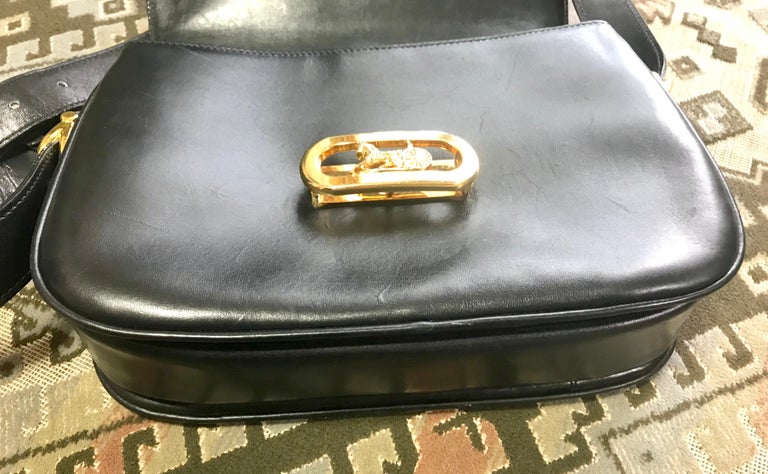 Vintage Celine black leather classic shoulder bag with golden logo closure. For Sale 1