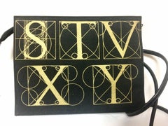 Vintage Paloma Picasso black shoulder bag with gold letter prints.