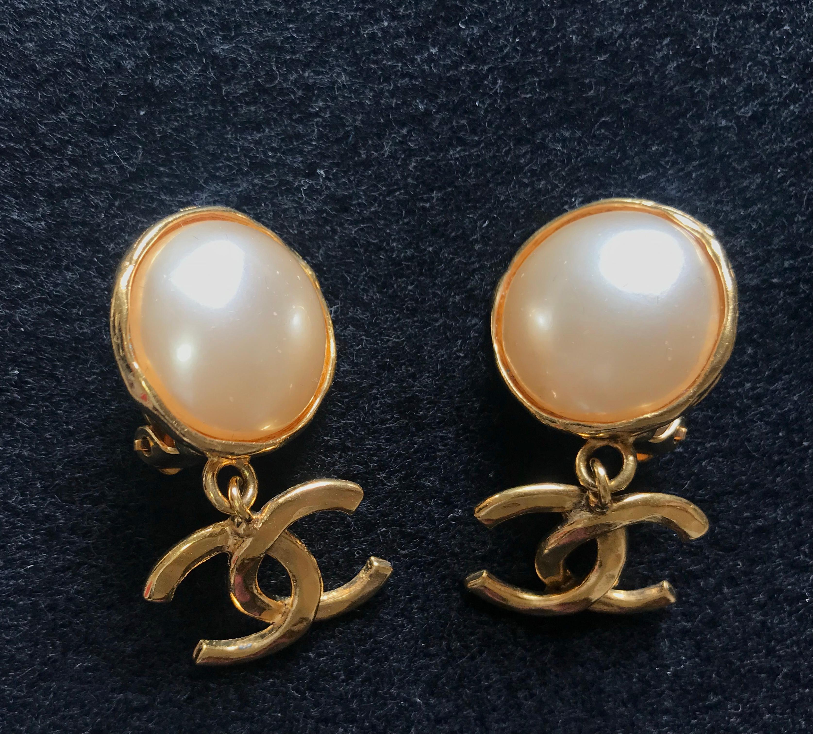 1990s. Vintage CHANEL classic round white faux pearl and golden CC dangling earrings. Iconic CC mark. Hot gift.

Introducing another classic vintage CHANEL jewelry,  white faux pearl earrings with golden CC marks that dangle as you move!
Wearing