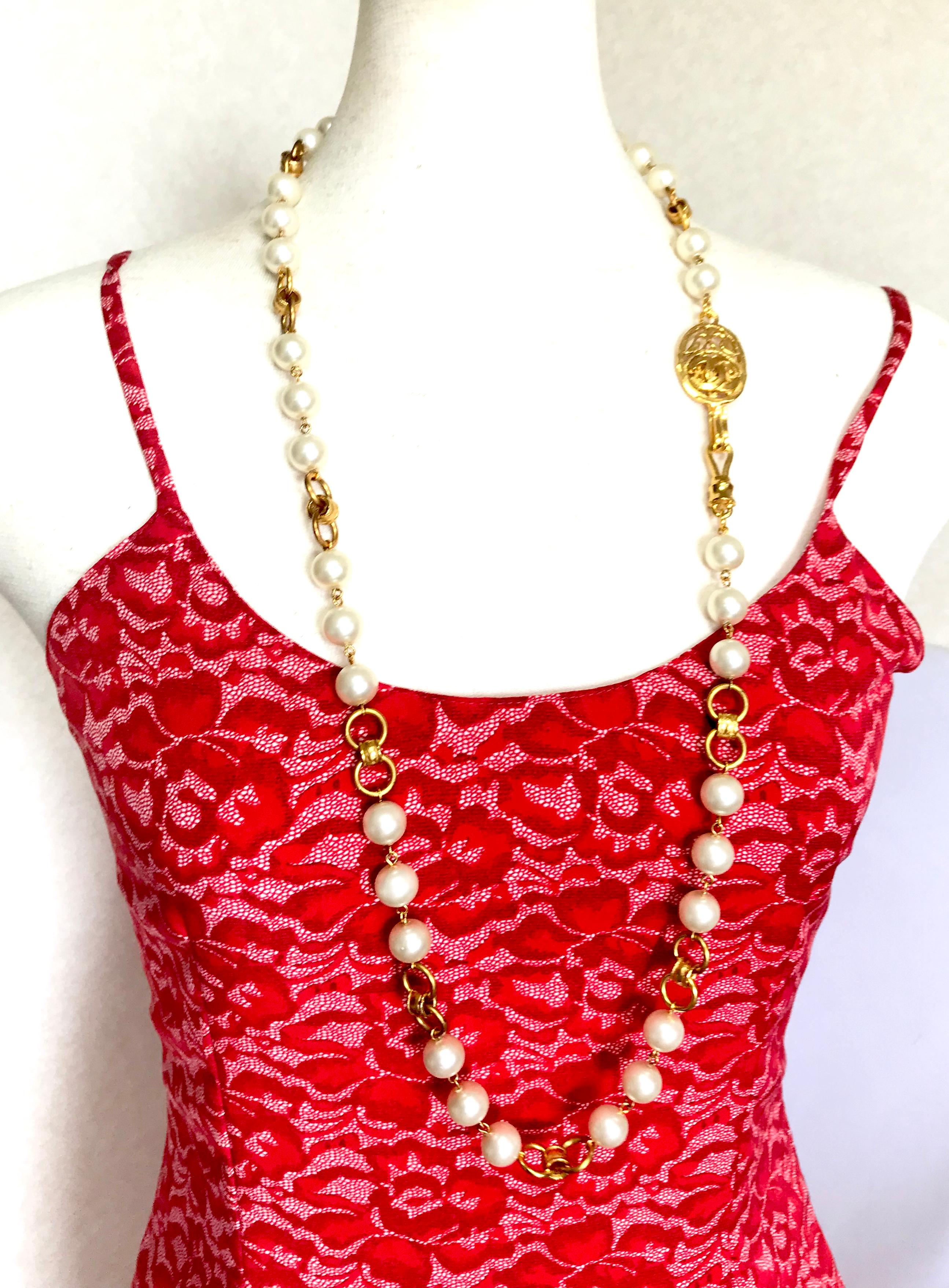 1990s. Vintage CHANEL golden long chain and faux pearl necklace with oval arabesque CC mark motif. Can be worn in double and used as a belt as well. 
Perfect and gorgeous Chanel gift.  

Depending on your outfit and feeling, you can wear it in