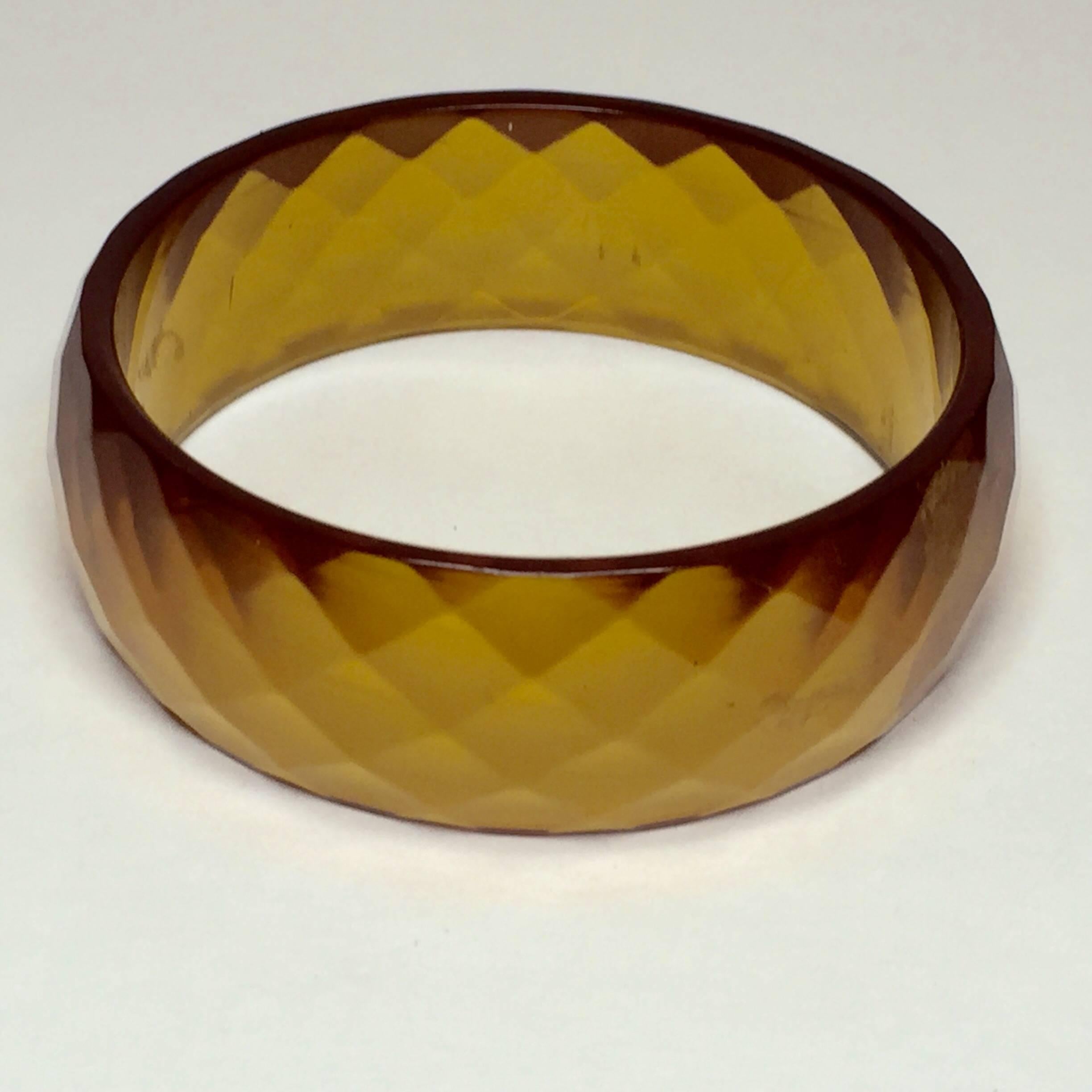 A triad of three allied yet contrasty 1930's bakelite bangles in lusciously translucent apple juice bakelite, includes all 3 THREE bangles pictured in the group, individually, as well as in close up view. The star is of course the 3/4 
