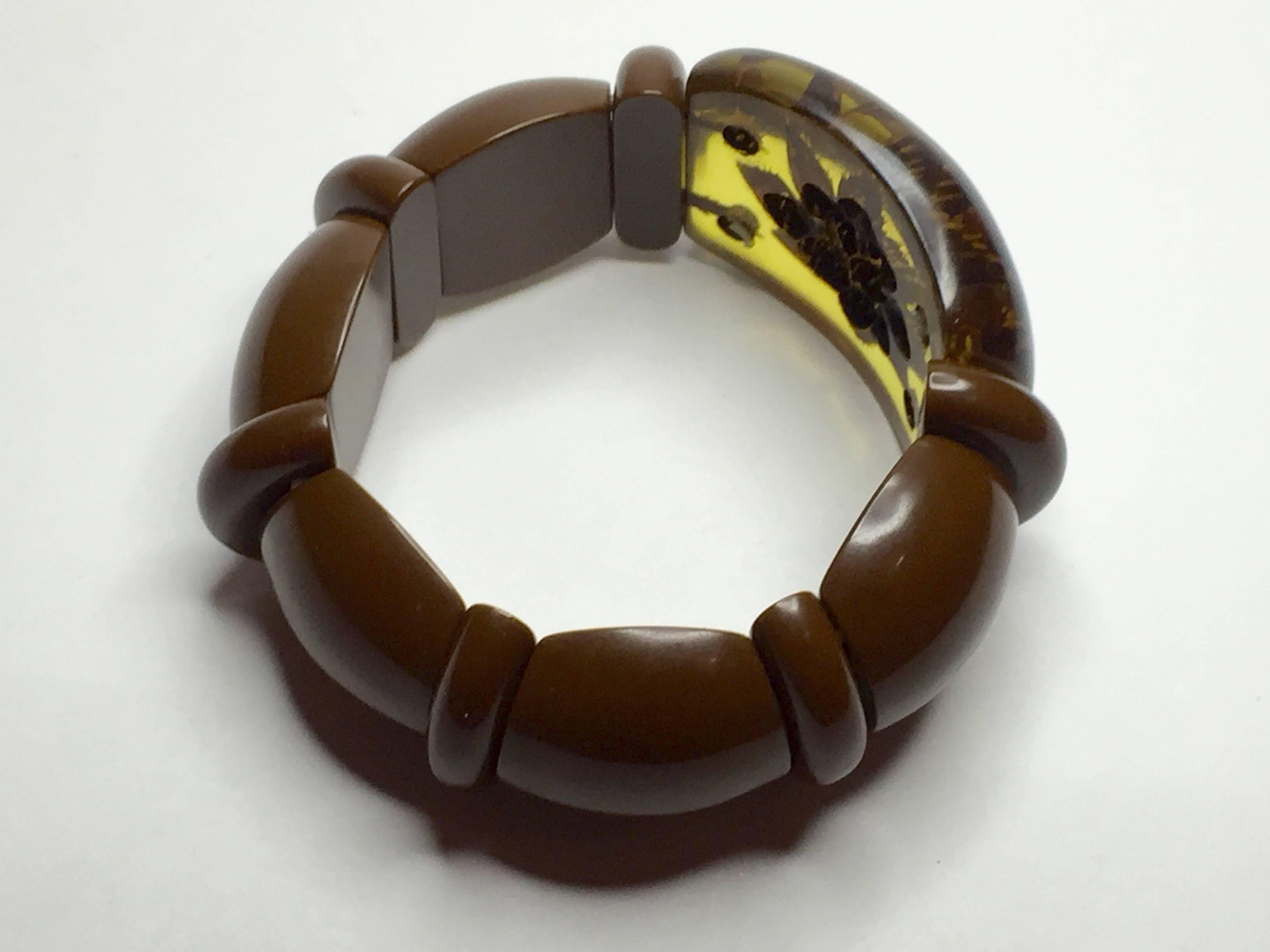 This classic Bakelite stretch bracelet in rich brown and apple juice bakelite with a mysterious and elegant reverse carved floral brown detail is a pillar of the world of collecting and wearing Fine Bakelite jewelry. Flat backed brown bakelite