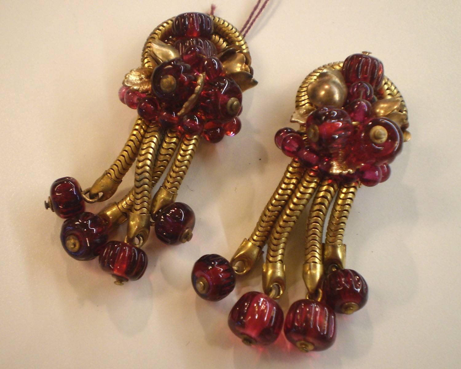 These 1960's Robert Rousselet Cranberry Gripoix Glass and Goldtone Drop Earrings are very much in the style of Coco Chanel. Marked FRANCE and with appropriate french earring clipback hardware, these elegant moderne yet glamorous translucent carved