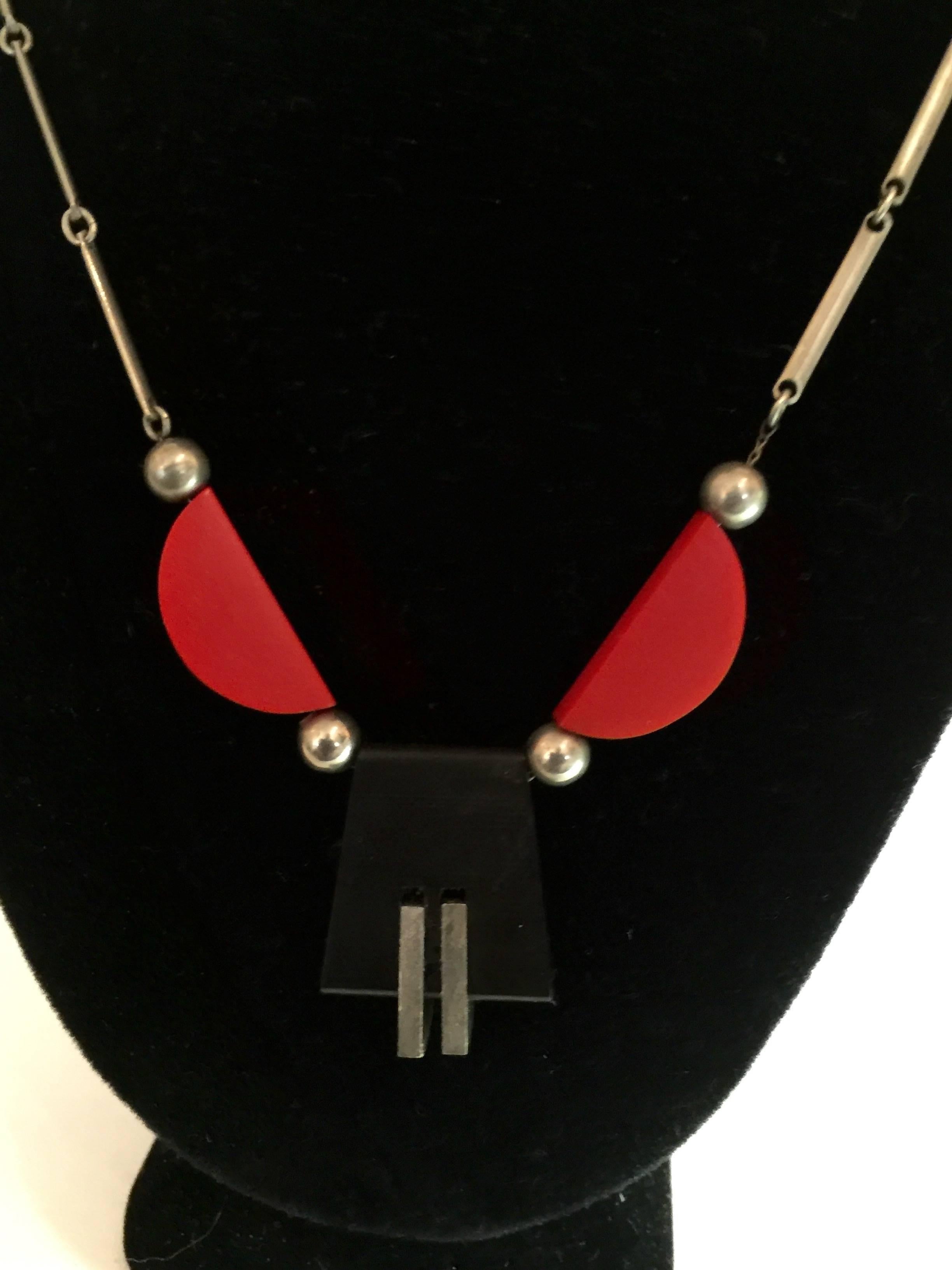 This 1930s German Art Deco Chrome Red and Black Galalith Necklace by Jacob Bengel is a classic example of this master of German Modernist jewelry  love of geometry, and the symbiosis between industrial chrome and the plastic material GALALITH, a