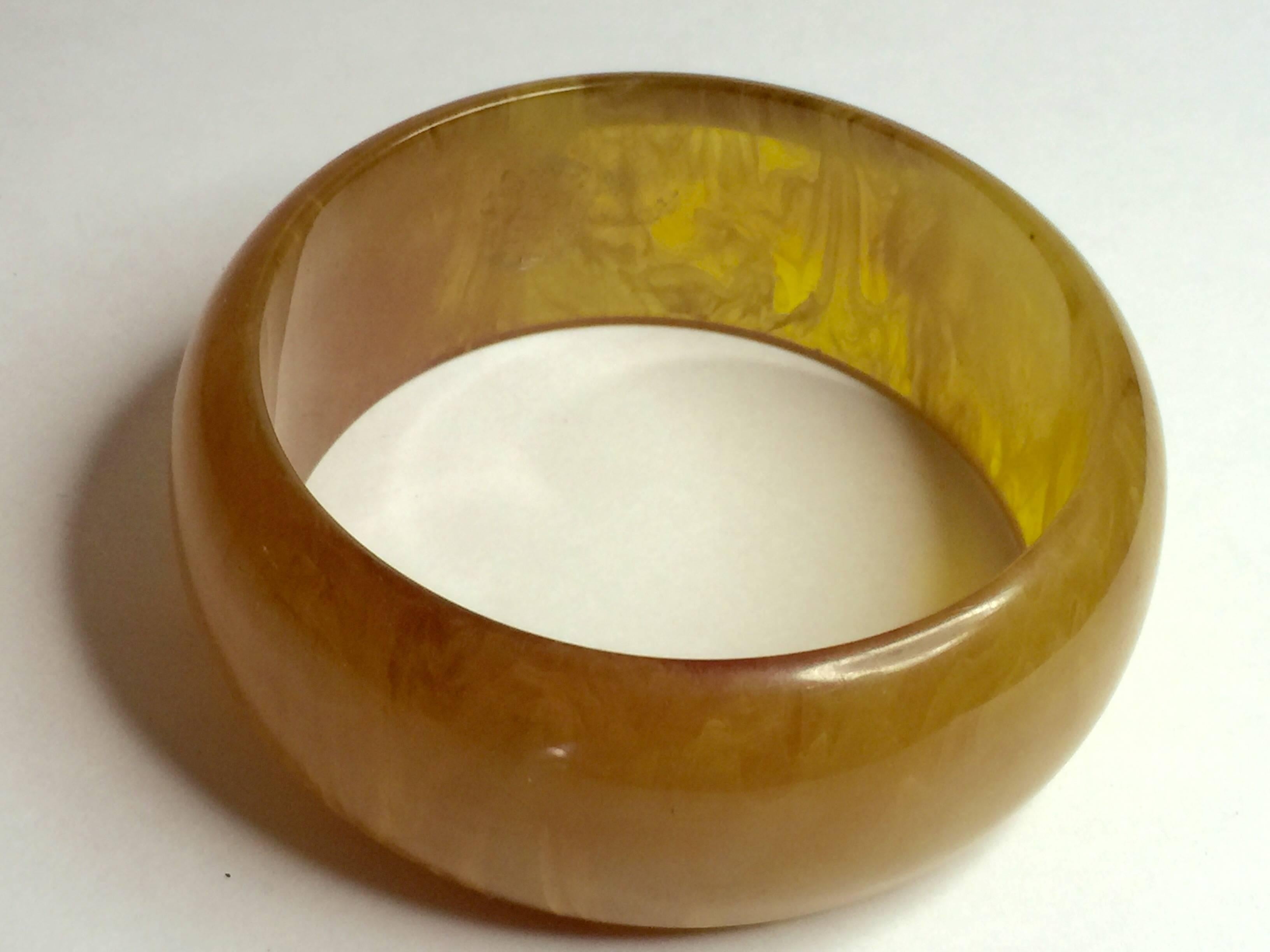 This luscious 1930's Swirled Bakelite Faux Amber Bangle Bracelet has a standard inner diameter of approximately 2.5