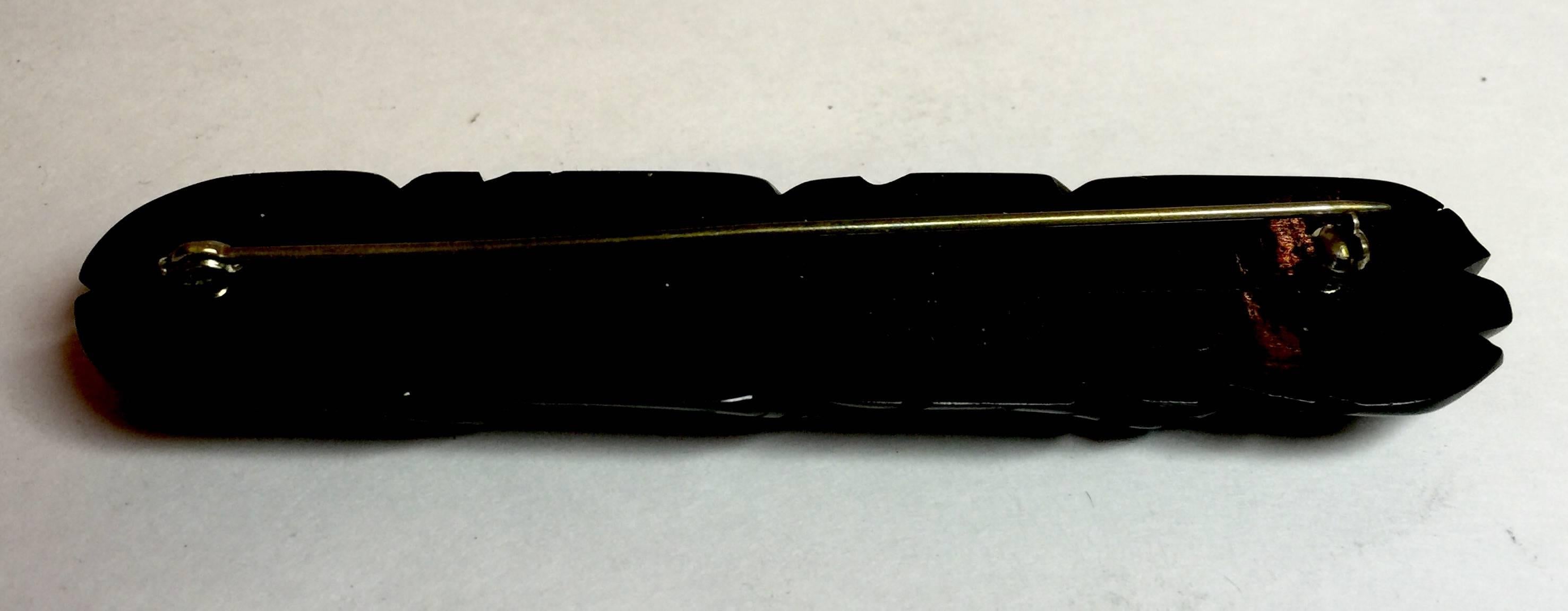 This 1930s Art Deco Black Bakelite Heavily Carved Bar Pin has LEAVES carved into it in horizontal rows. The carving detail is sharp and quite sculptural. This classic design emulates similar Victorian designs in jet from earlier eras. Its