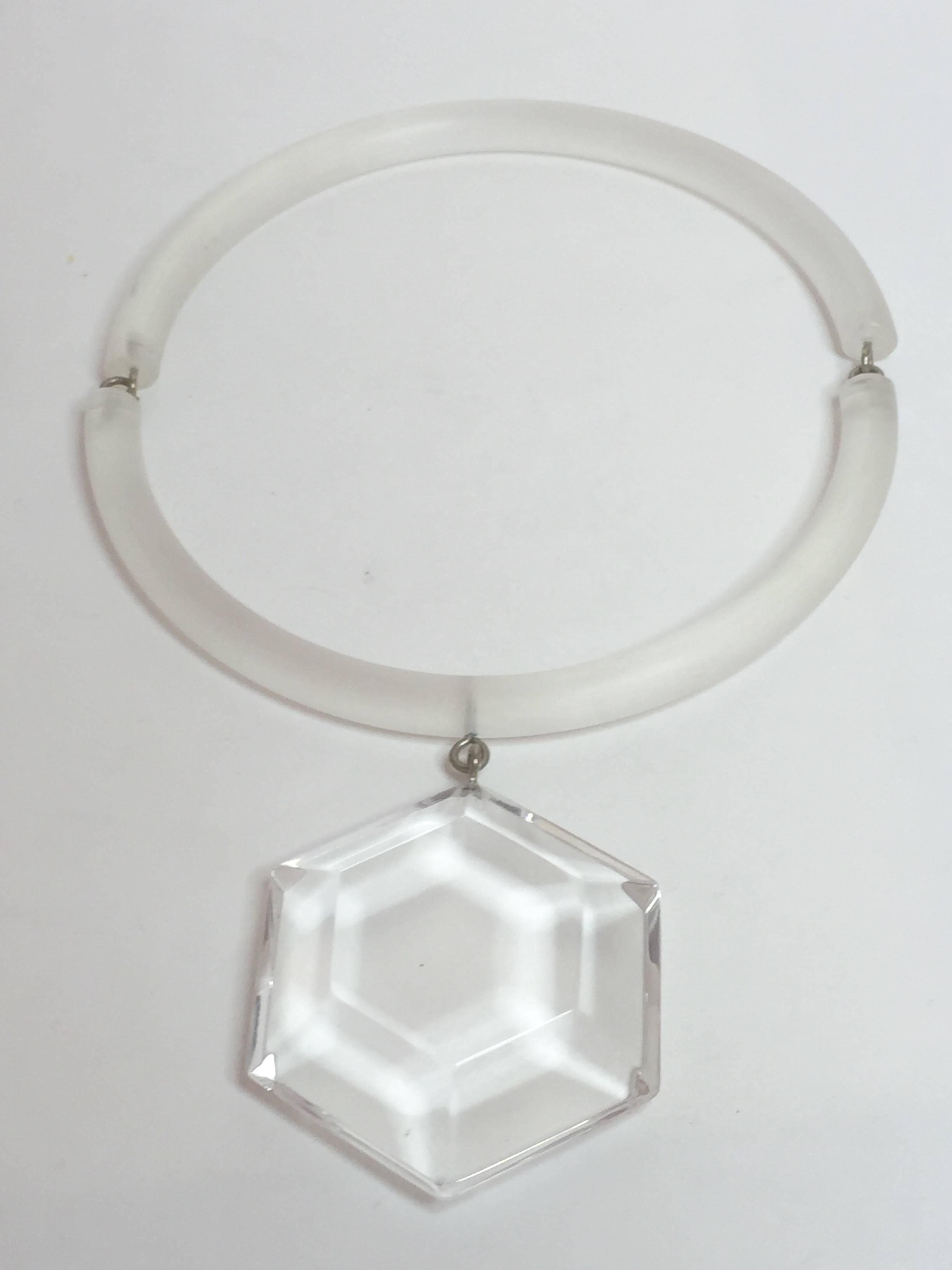 Lavish, luxe  and yet simple and elegant, this gorgeous frosted clear neck ring by Judith Hendler suspends a thick, chunky faceted hexagonal crystal colored acrylic pendant. Always worn with the closure on the wearer's left side, the O-ring and