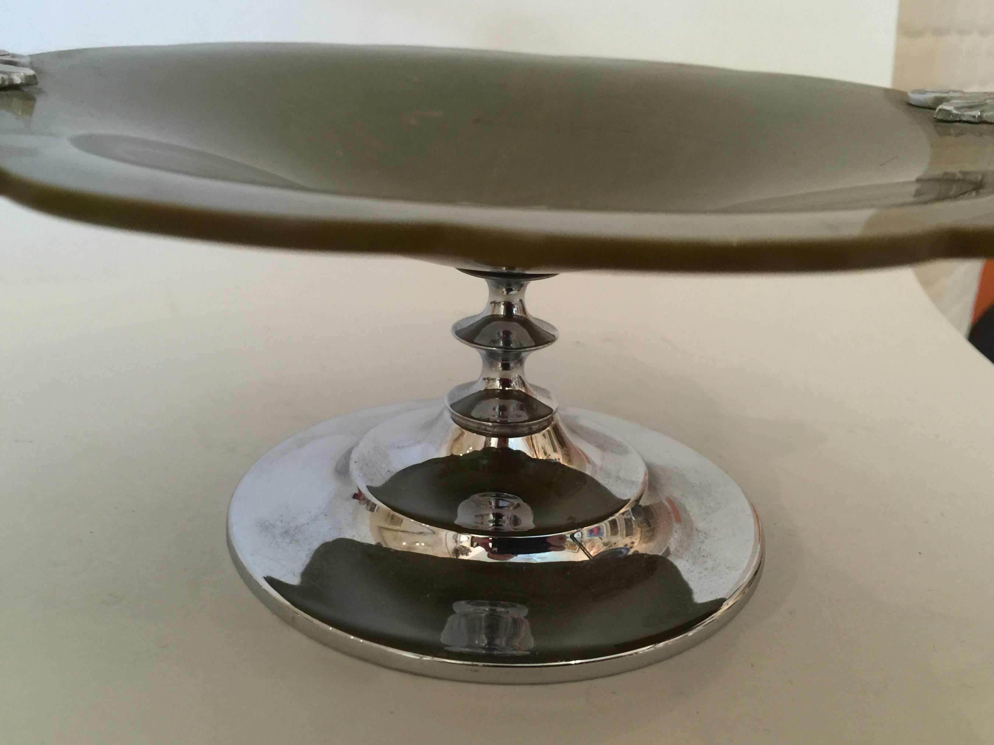 Bakelite and Chrome allied together is one of the most classic art deco material combinations. This Manning Bowman Pin Dish for the vanity table is archetypally art deco in tone and form. The machine age chrome footed concentric circular base is