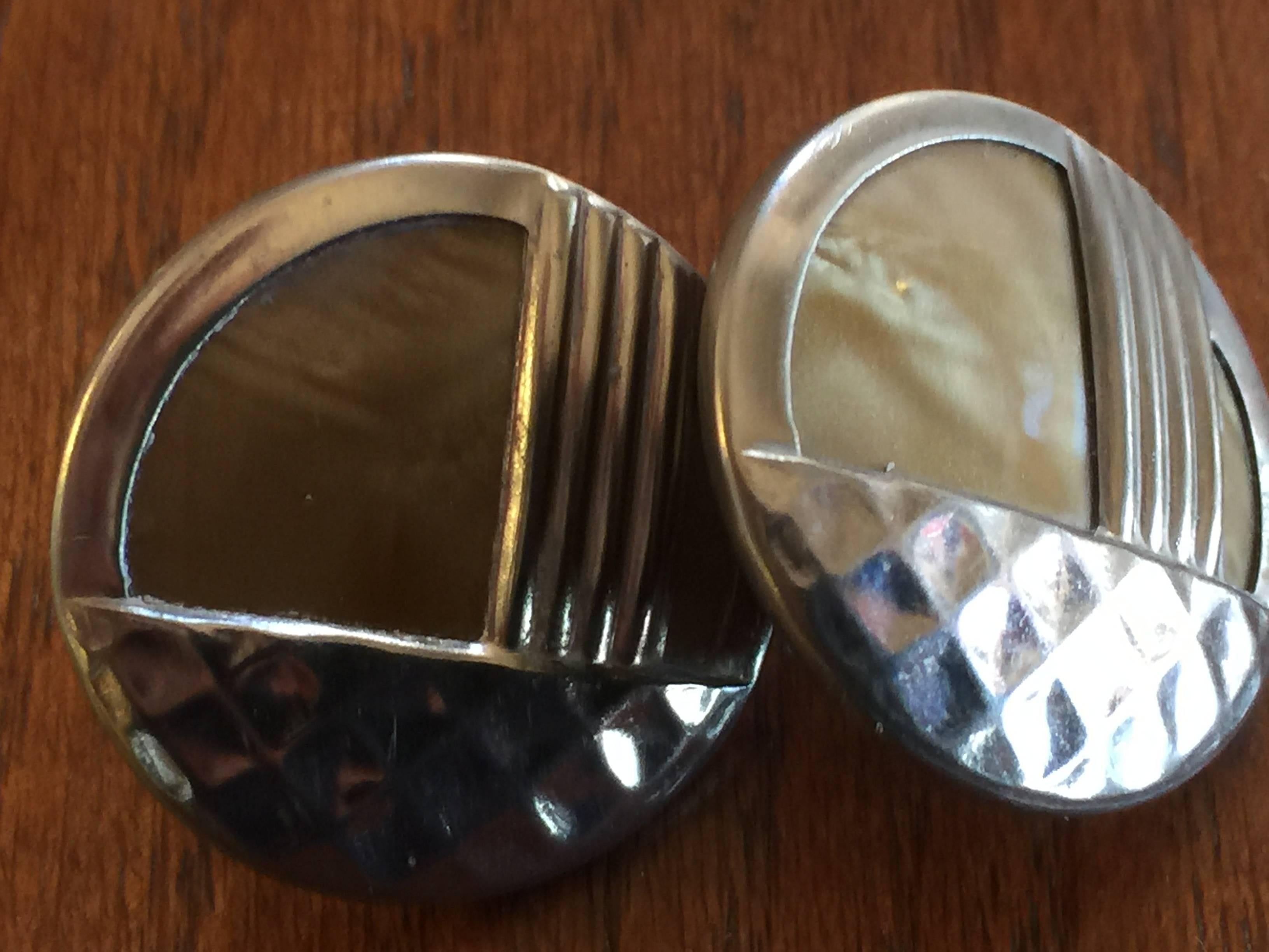 These 1930s Art Deco Silver Overlay Celluloid Pierced Earrings are most probably converted from buttons into earrings. The silver overlay work is superb and wraps vaccum style around the entirety of the back of the earring. Pierced backs.