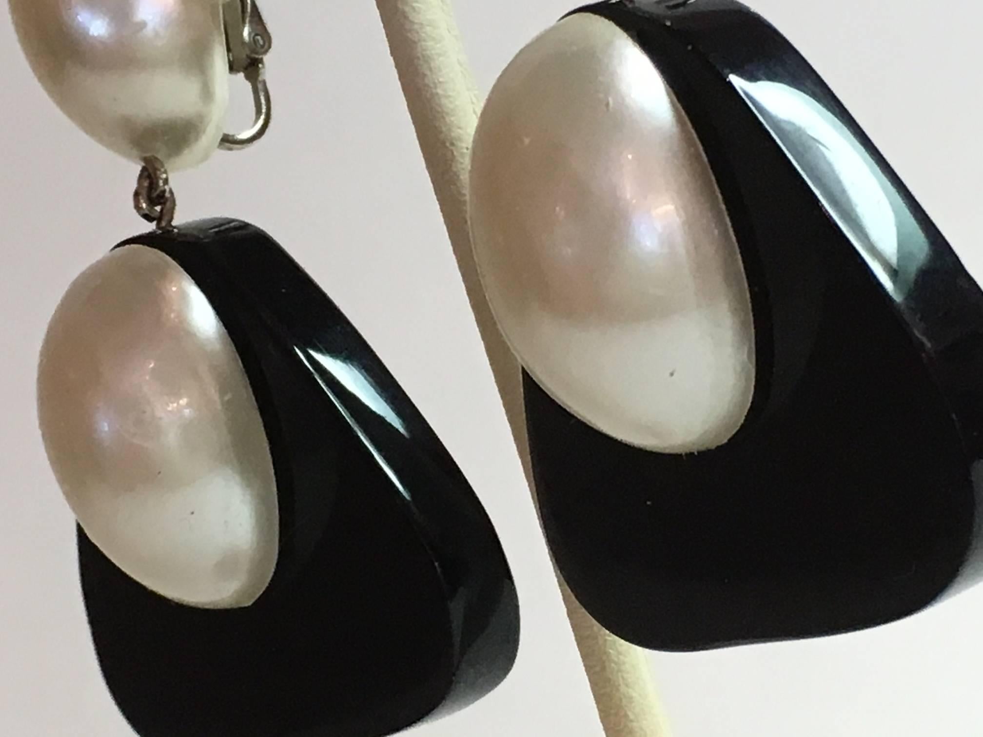 These lovely fingernail pearl style earrings in black acrylic with oval pearl accents, Fingernail domed pearl top element suspend rounded triangular black acrylic drops with additional pearl domed set accents.. The  tops are under 1