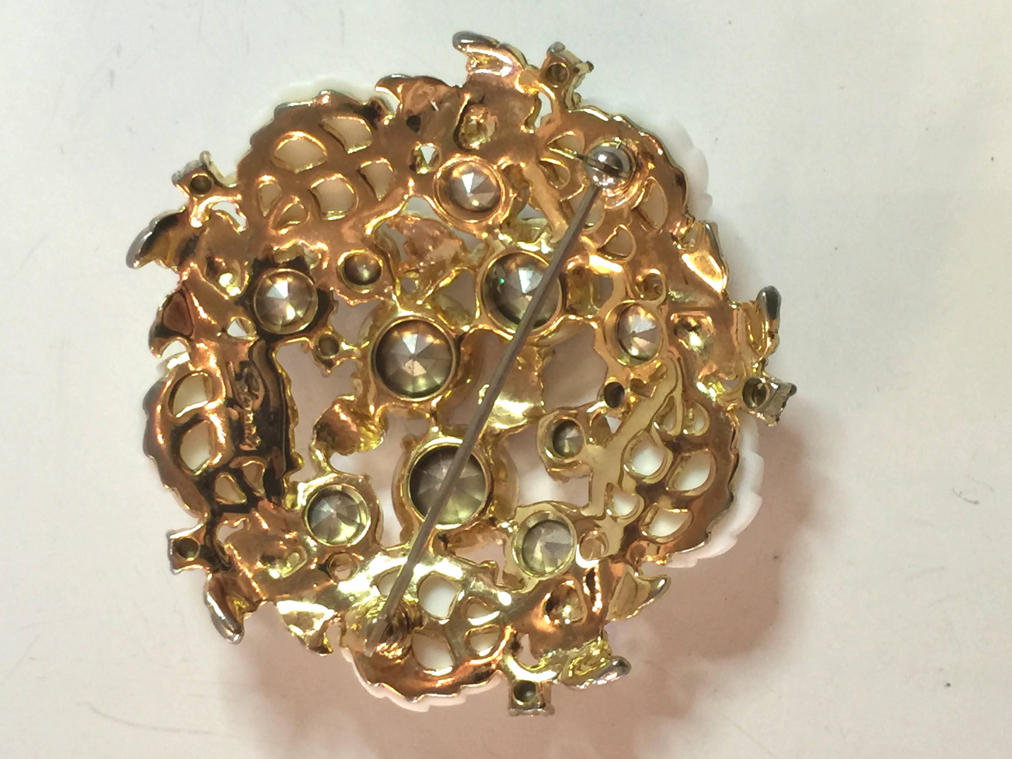 Confection-like and dazzling, this wonderful white 1950s SCHIAPARELLI Borealis  Rhinestone Goldtone Floral Brooch Pin sparkles with a sweet sugary lightness... rare and completely alluring. Unusual molded leaf borealis stones glow in rainbow hues,