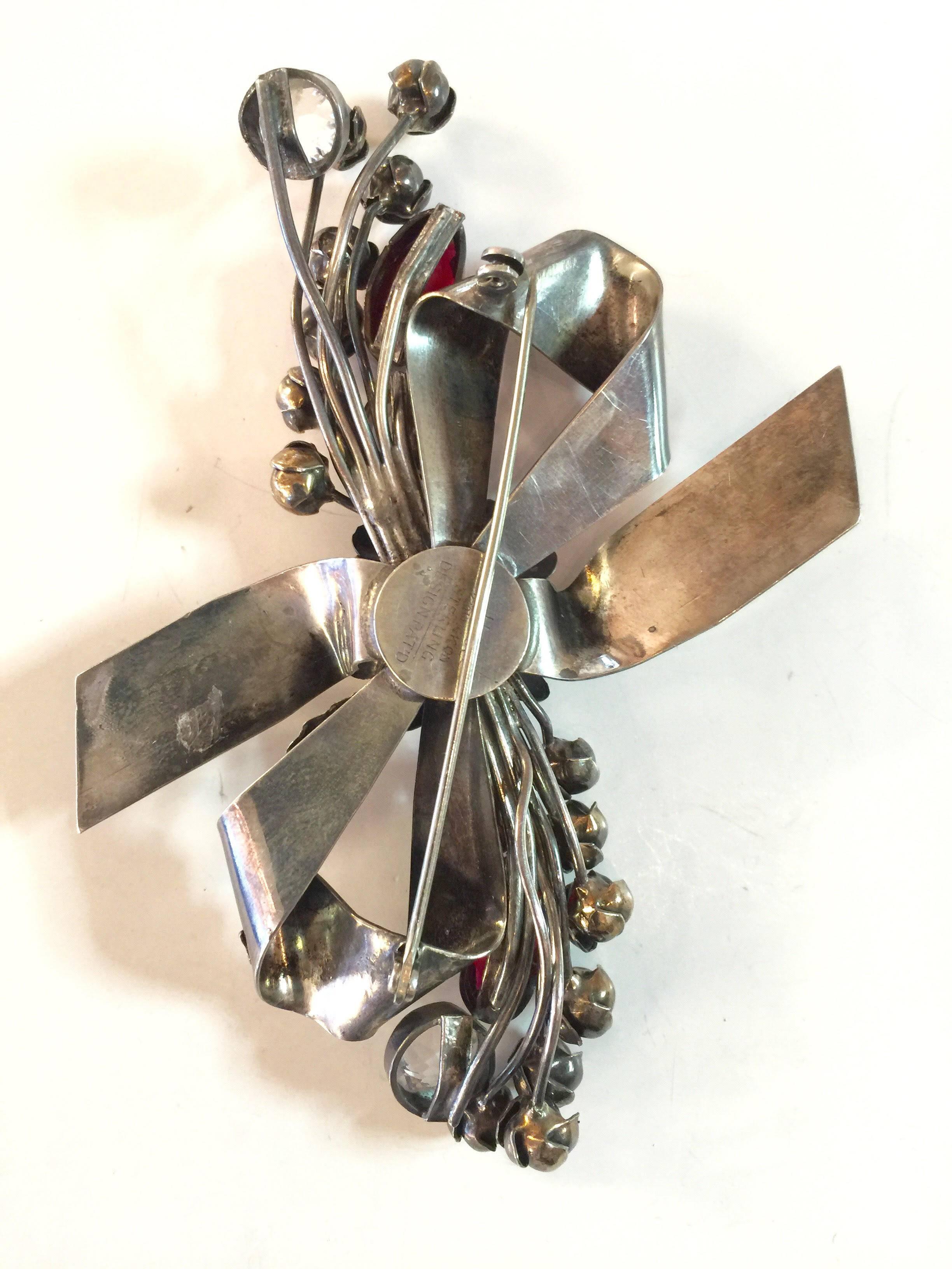 An exquisite classic Hobe sterling floral spray brooch with a bow theme, this large brooch measures approximately 4