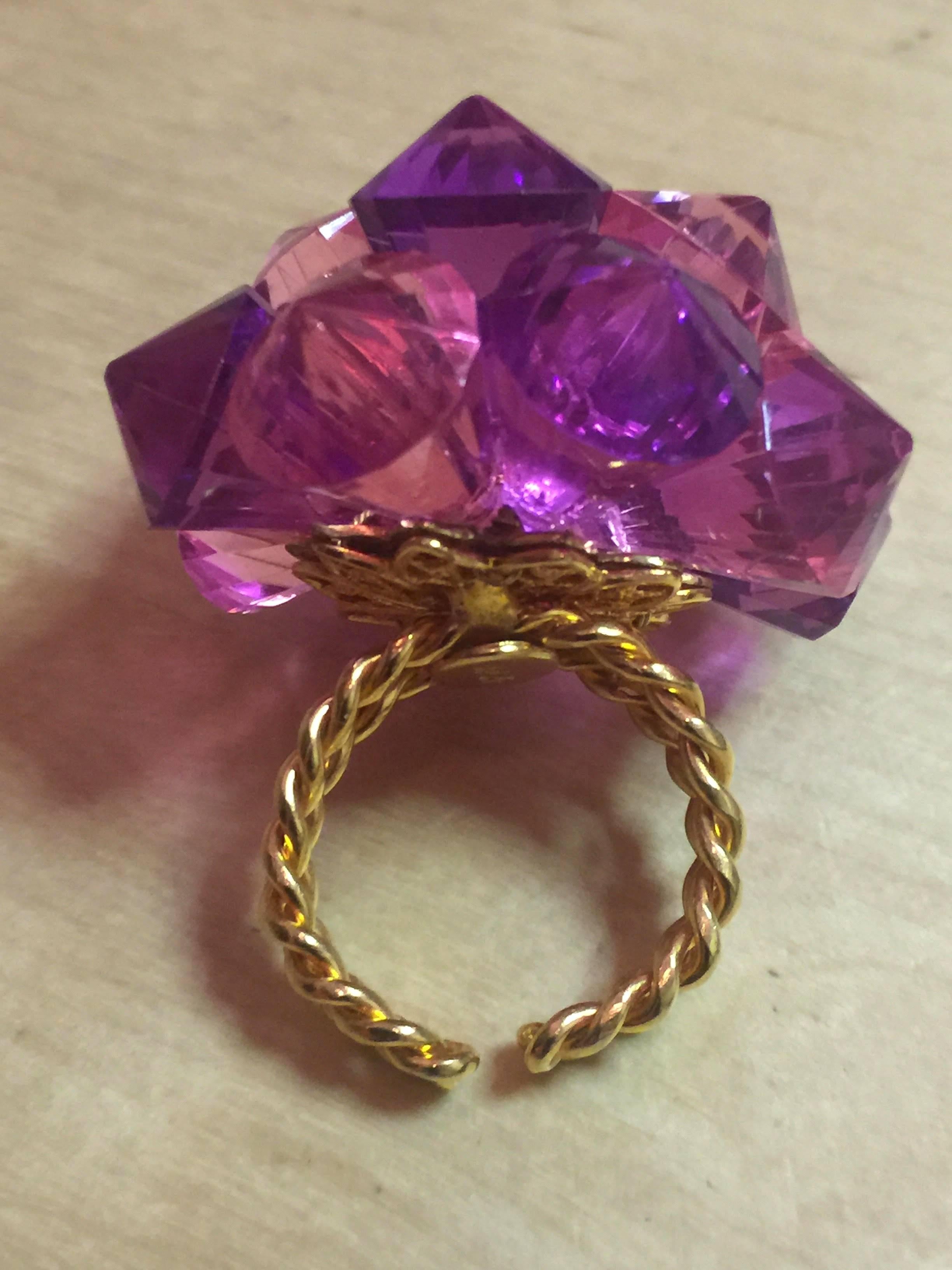 Always fun, always fashionable, this 1970s William DeLillo Pink Purple Acrylic Adjustable Size Fabulous RING makes quite the POP statement. 12 diamond tipped faceted crystals in acrylic wired together alternating pink and purple tones make for a