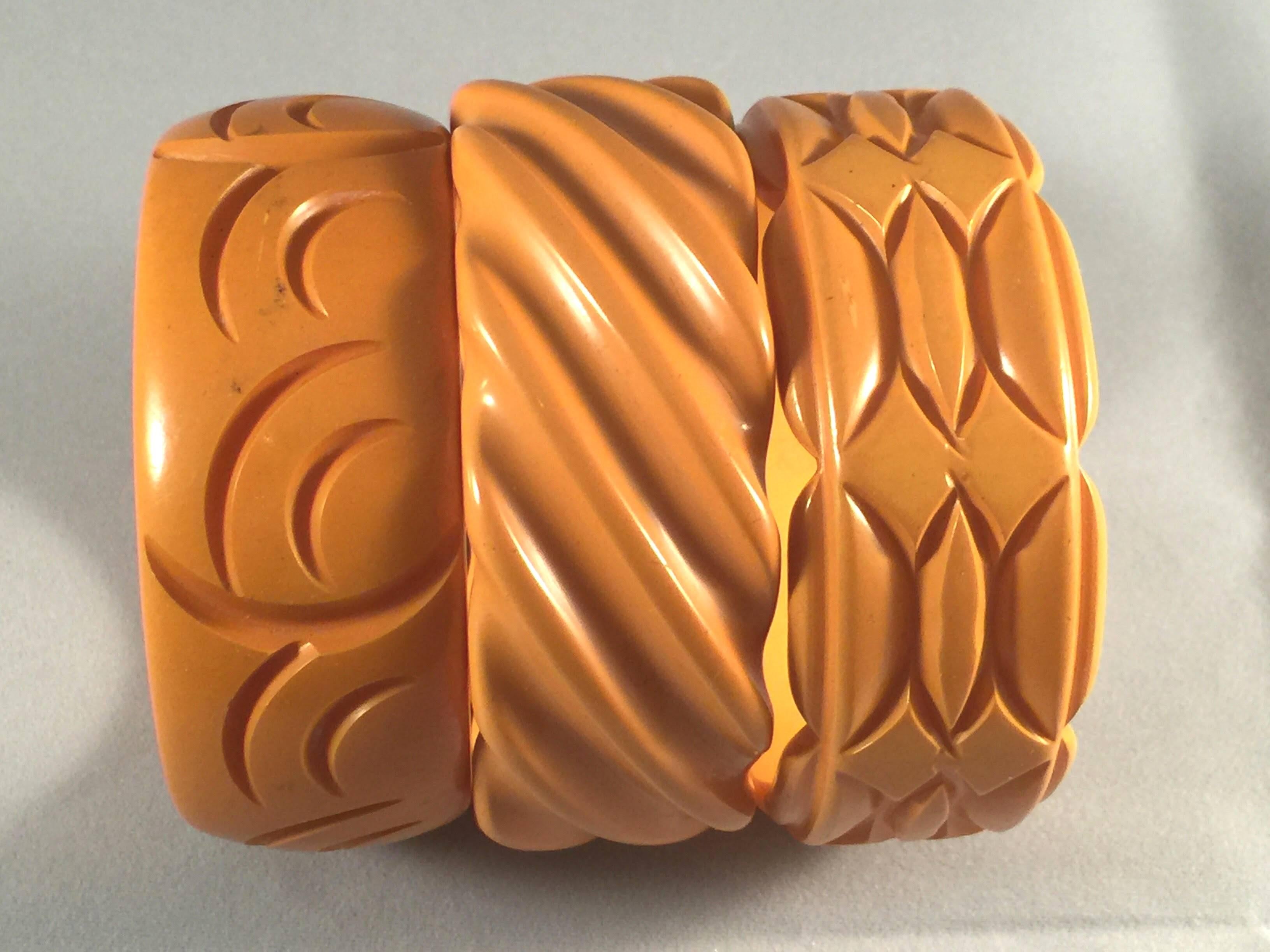 This group of three 1930s bakelite bangles in rich buttercream tones are classic thick chunky bangles which represent the beauty and the art of wearing bakelite bangles. Three bangles, each almost an inch wide, with standard inner diameters of 2.5
