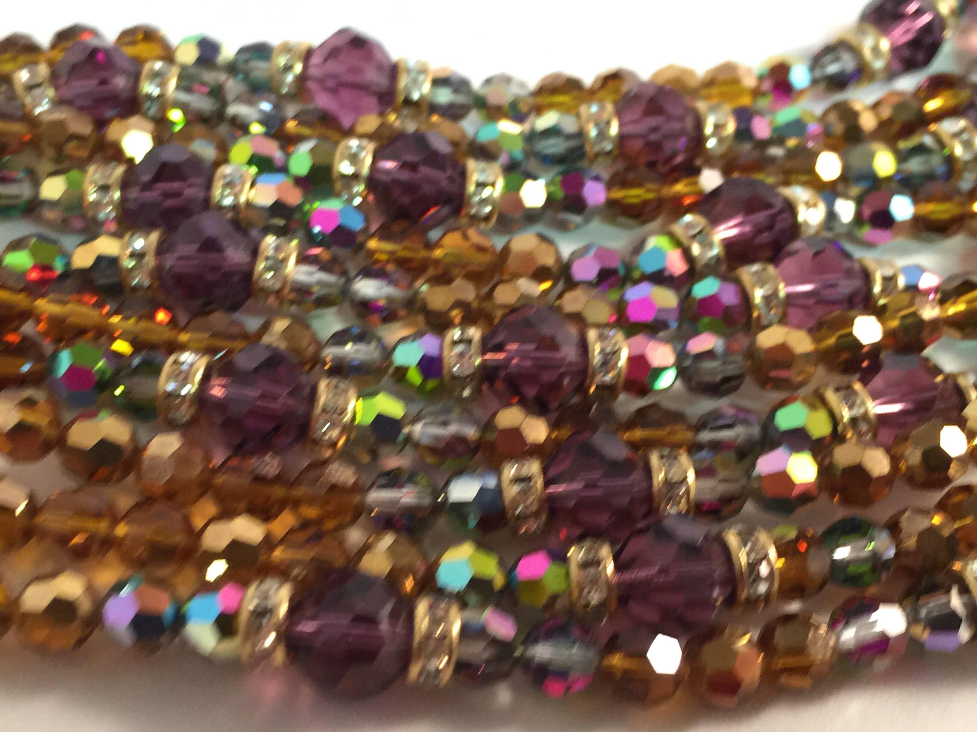 A gorgeous classic crystal bracelet, by the iconic designer William deLillo dates from circa 1970 and is comprised of 10 strands of dazzling multicolor faux topaz, amethyst and smoke aurora borealis faceted crystals, accented with interspersed white