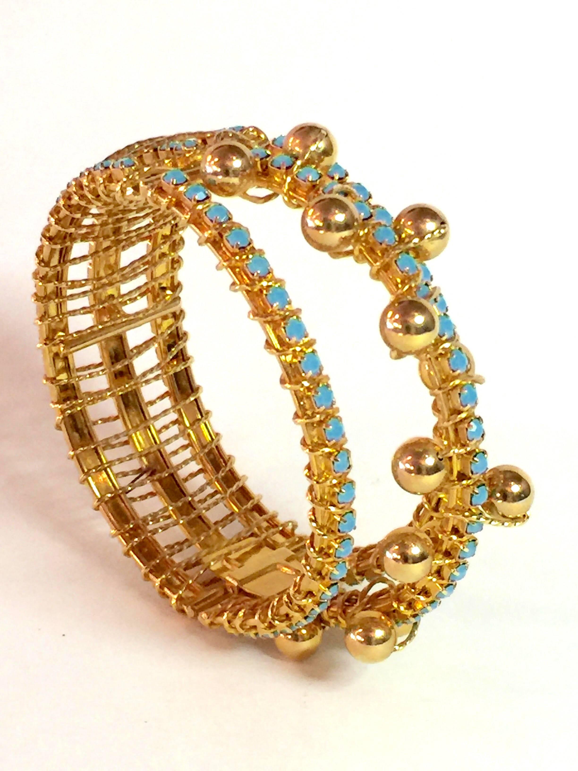 An amazingly constructed hinged bracelet by storied designer William deLillo, this piece is highly dimensional on the wrist and is 1" wide at its narrowest and contours around to 1.5" wide at its centerpoint. Three rows of luscious aqua