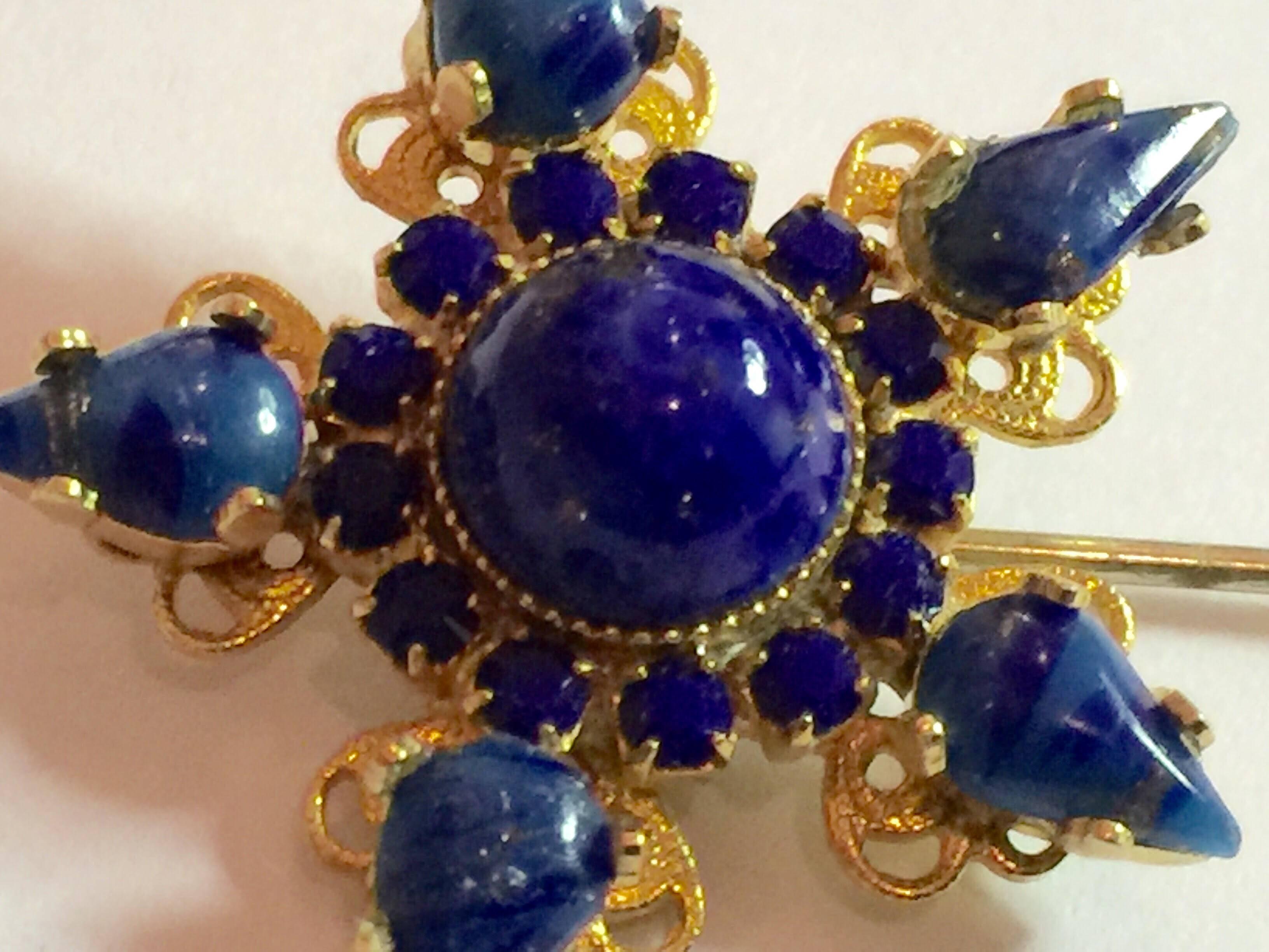 Always elegant jabot style hat pins have been made by a wide variety of costume jewelry designers. This gold toned faux lapis star shaped jabot pin is approximately 1.1 inches square (the star) and the entirety of the brooch is 3 inches long. It