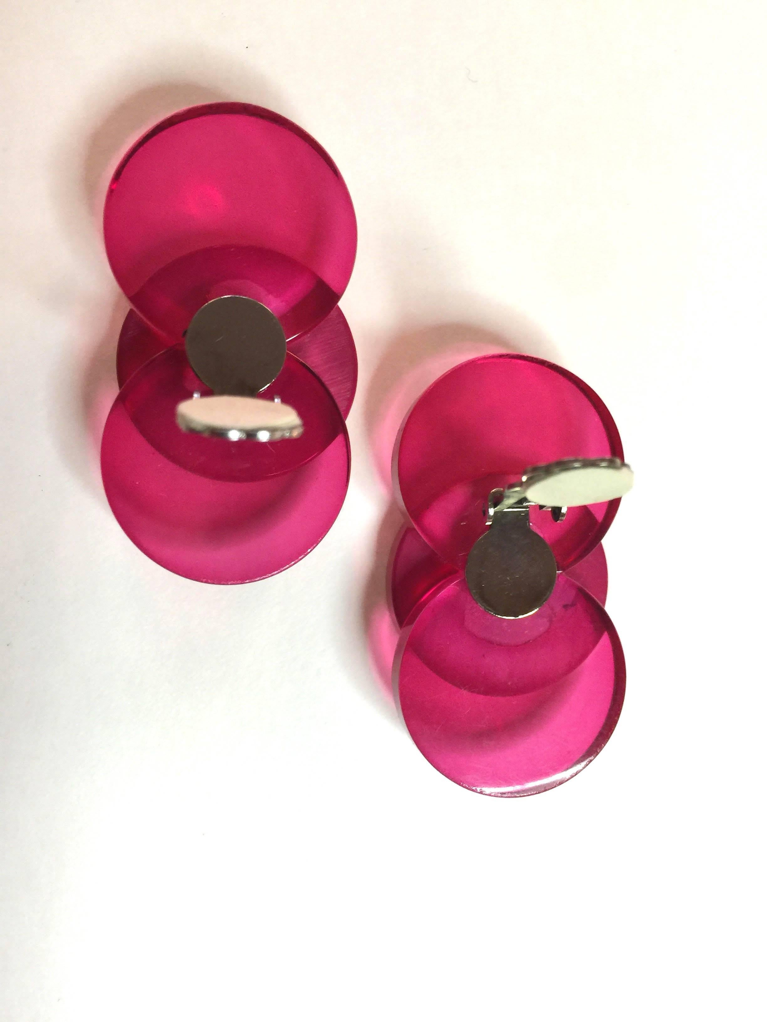 These 1980s  translucent and opaque hot pink acrylic earrings are an iconic Hendler acri-gems design, executed in many differing color combinations. The clip on mechanism is extant and functions perfectly. Each earring is constructed of 2 one inch