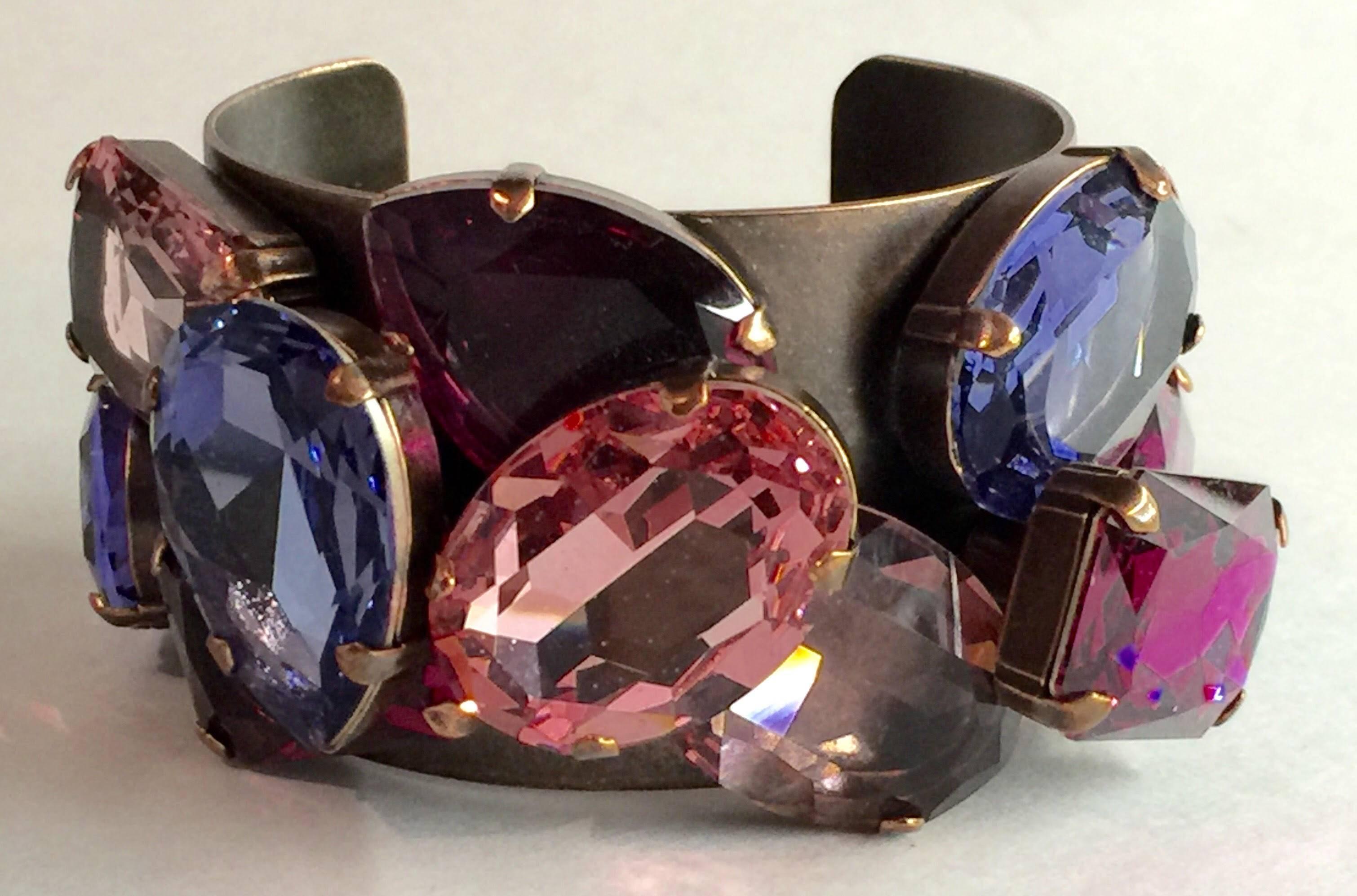 Dramatic and impactful indeed is this amazing LANVIN Brozed Copper Cuff Bracelet with Huge Rhinestone Detail. Shades of Pinki, Purple and Ice Blue are combined to great effect with huge sizes and prong setting work, this cuff is signed LANVIN with