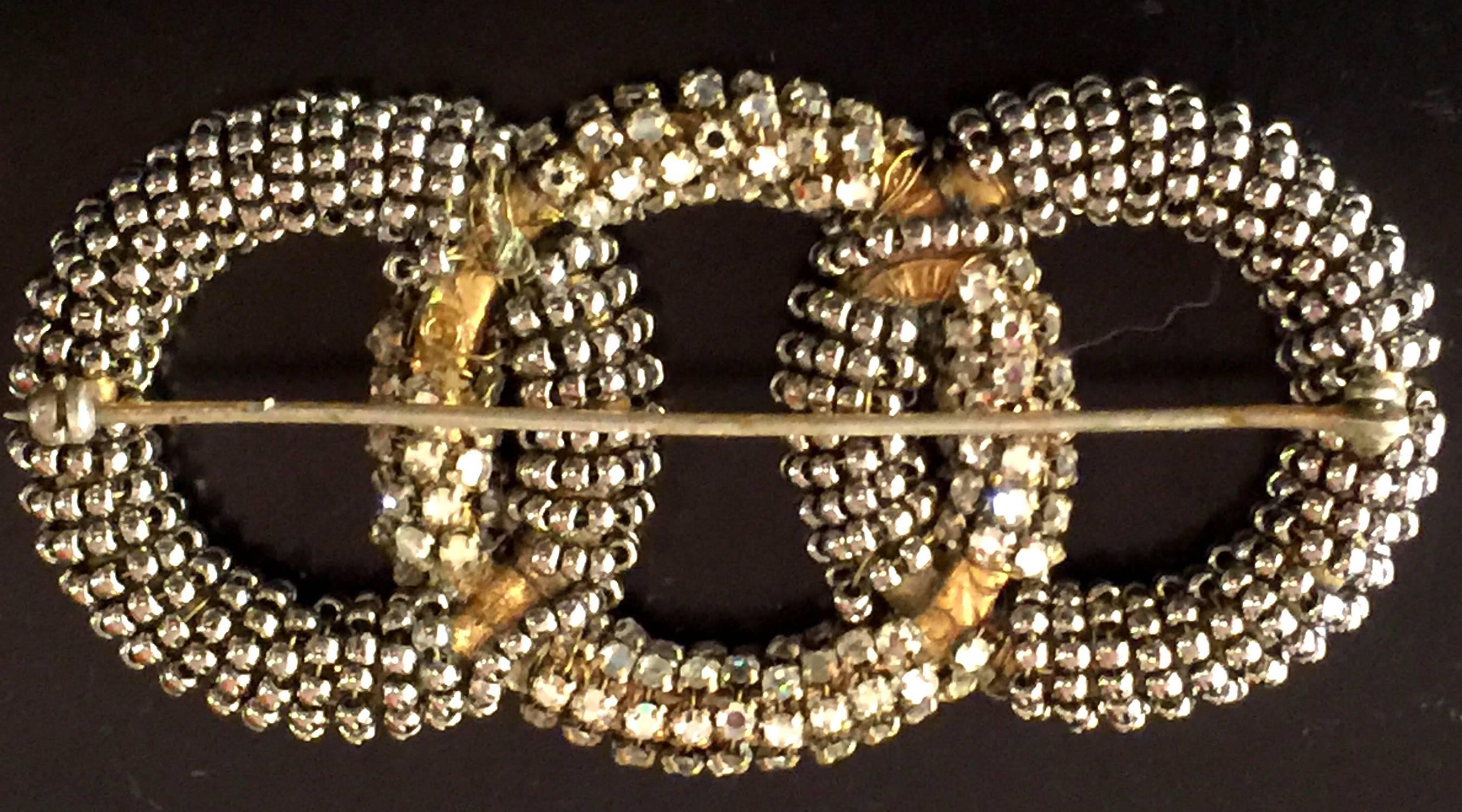 Intricate, yet elegant, this three interlocking circles pin by Miriam Haskell has both seed pearls and montee rhinestone detail in this tailored beauty of understated elegance. Approximately 3" long by 1" high this brooch has its original