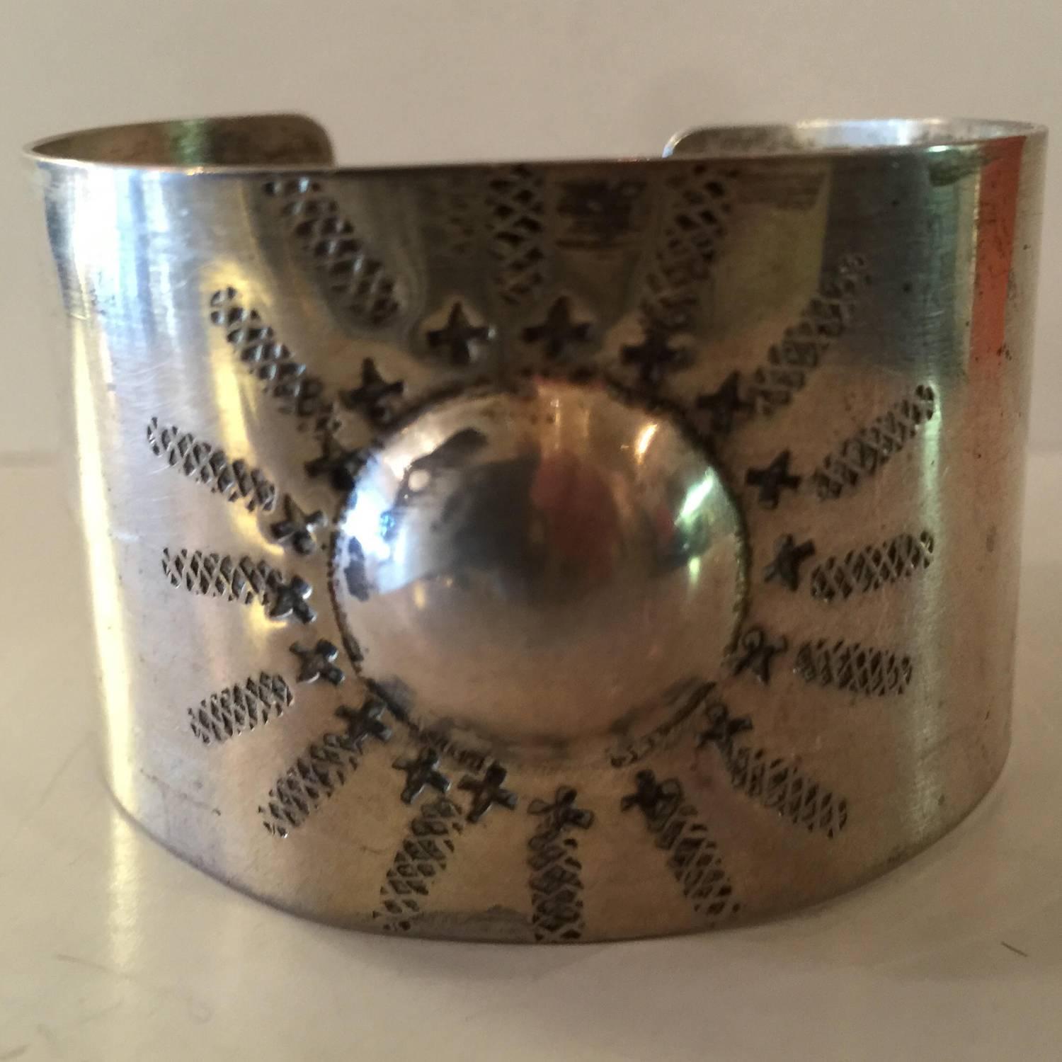This stylized sunburst embossed sterling silver cuff bracelet is an unusual work by Modernist master Rebajes. based in NY in the post war years, he was known for making handmade jewelry mostly in copper, but also did work in steling silver. Known