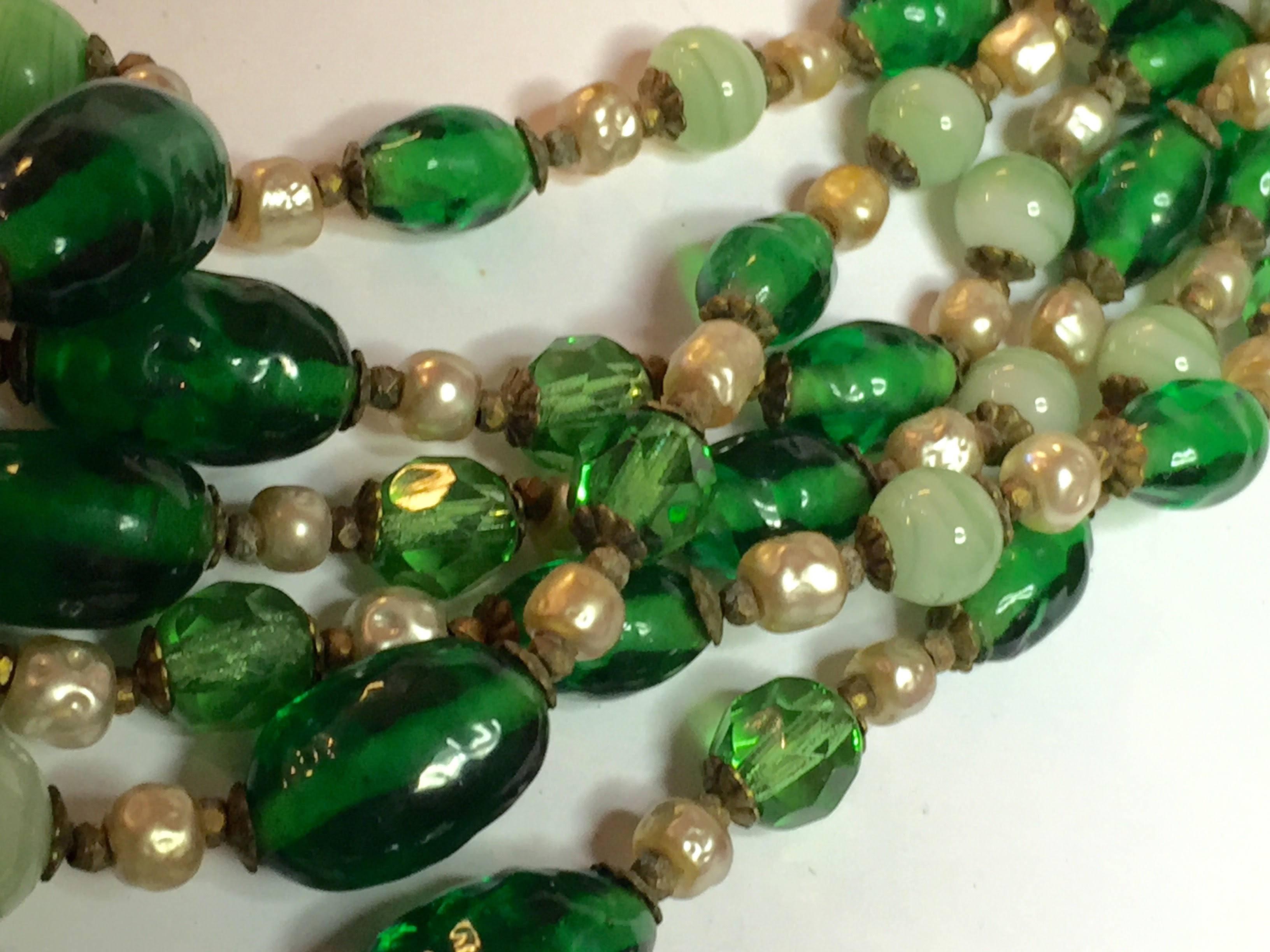 This lusciously verdant green MIRIAM HASKELL 6-strand necklace is created from a lovely baroque pearls, gold seed beads and seceral shades of celadon and other green venetian glass beads. Gold filigree workmanship is highly reflective of Haskell's