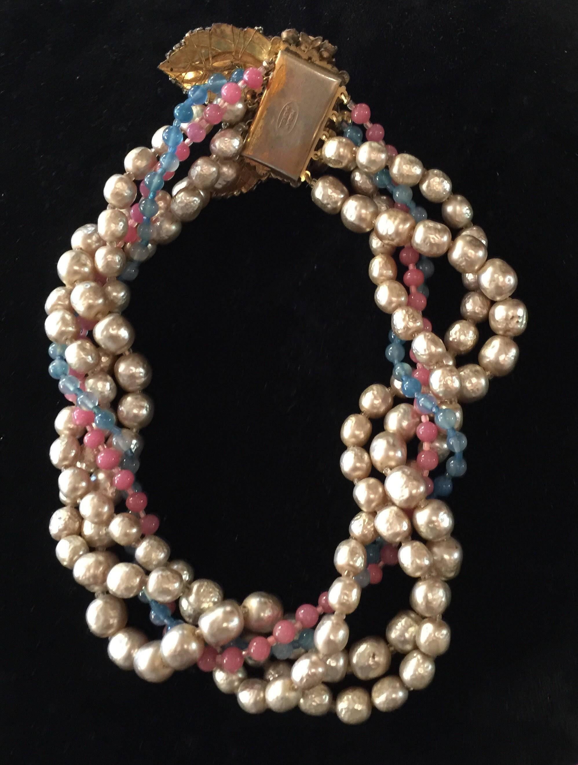 This luscious multistrand necklace by Miriam Haskell is the quintessence of Haskell workmanship, tone and style. A twisted rope necklace or tourcade, it can also be worn loosely, rather than twisted. An ultra elaborate seed pearl and montee clasp