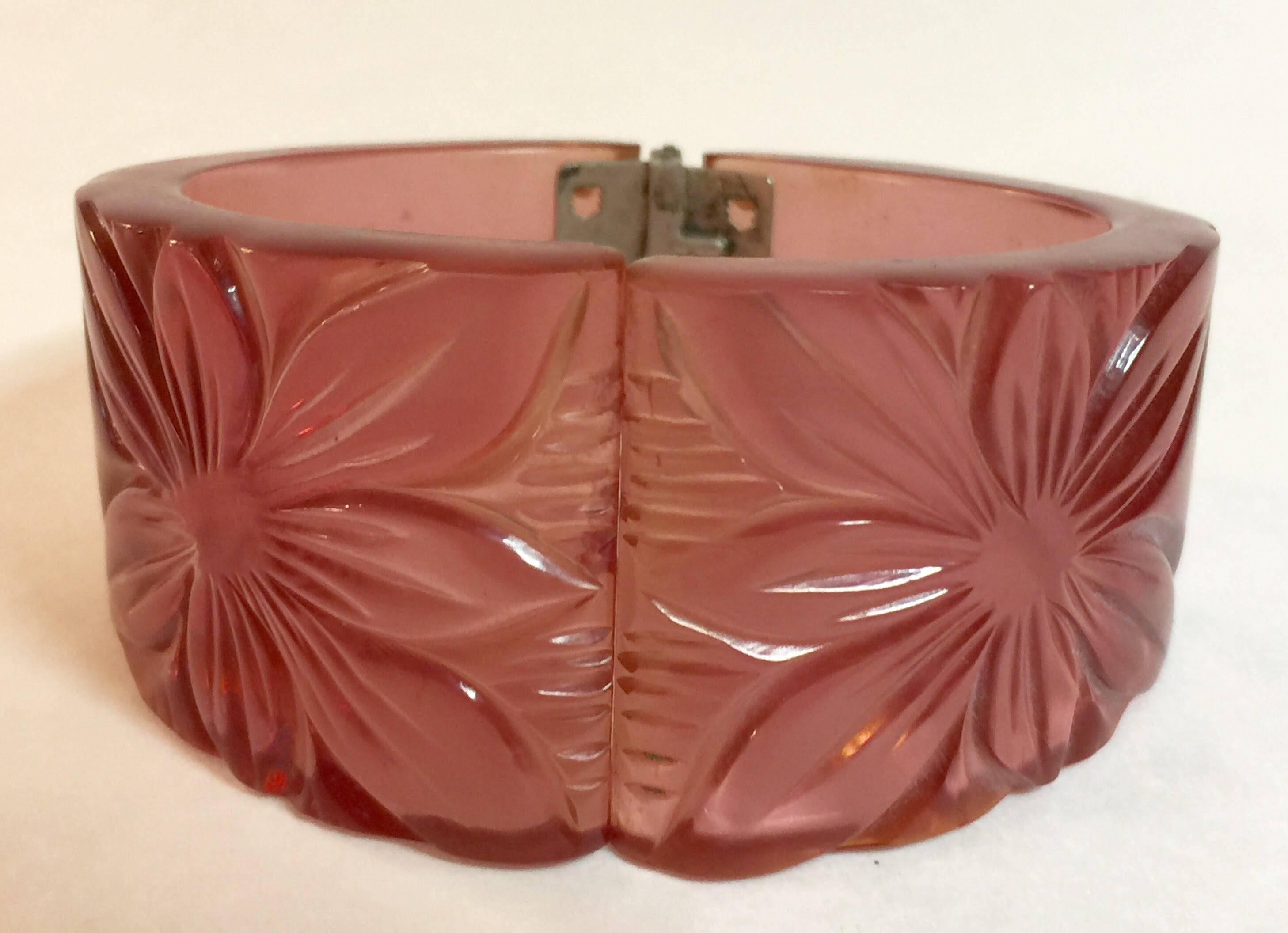 This utterly magical transparent pink floral carved center opening bakelite hinged bracelet is constructed of the rarest dichroic color shifting bakelite anywhere! Period 1930's and hand carved by unknown 1930's carvers, this bracelet is