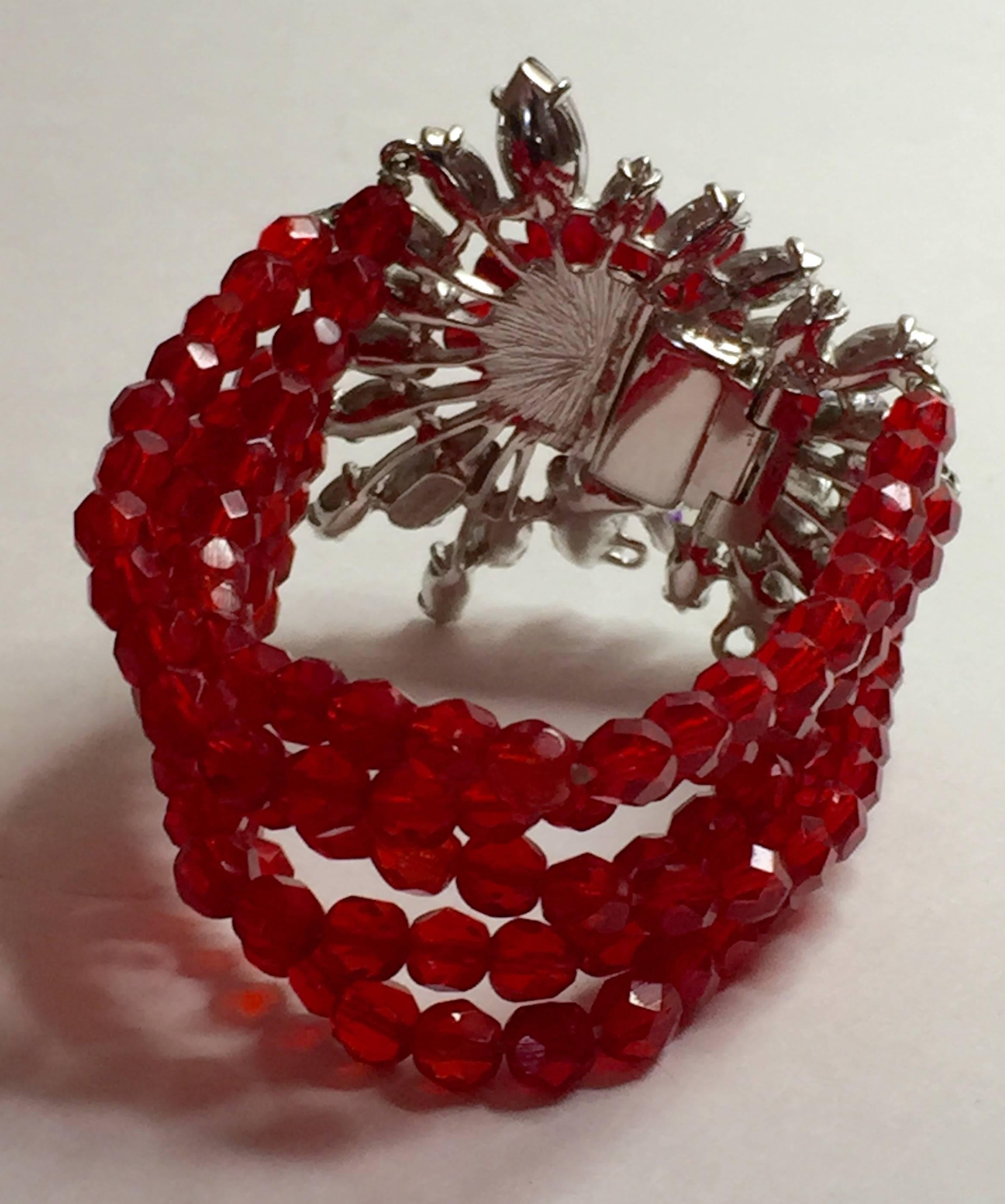 This SCHIAPARELLI  5-strand Faux Ruby Bracelet with Elaborate LUXE Stonework Clasp is a magnificent piece of designer vintage costume jewelry. Rhodium plated elaborate clasp is embellished with aurora borealis marquis shaped stonework and faux ruby